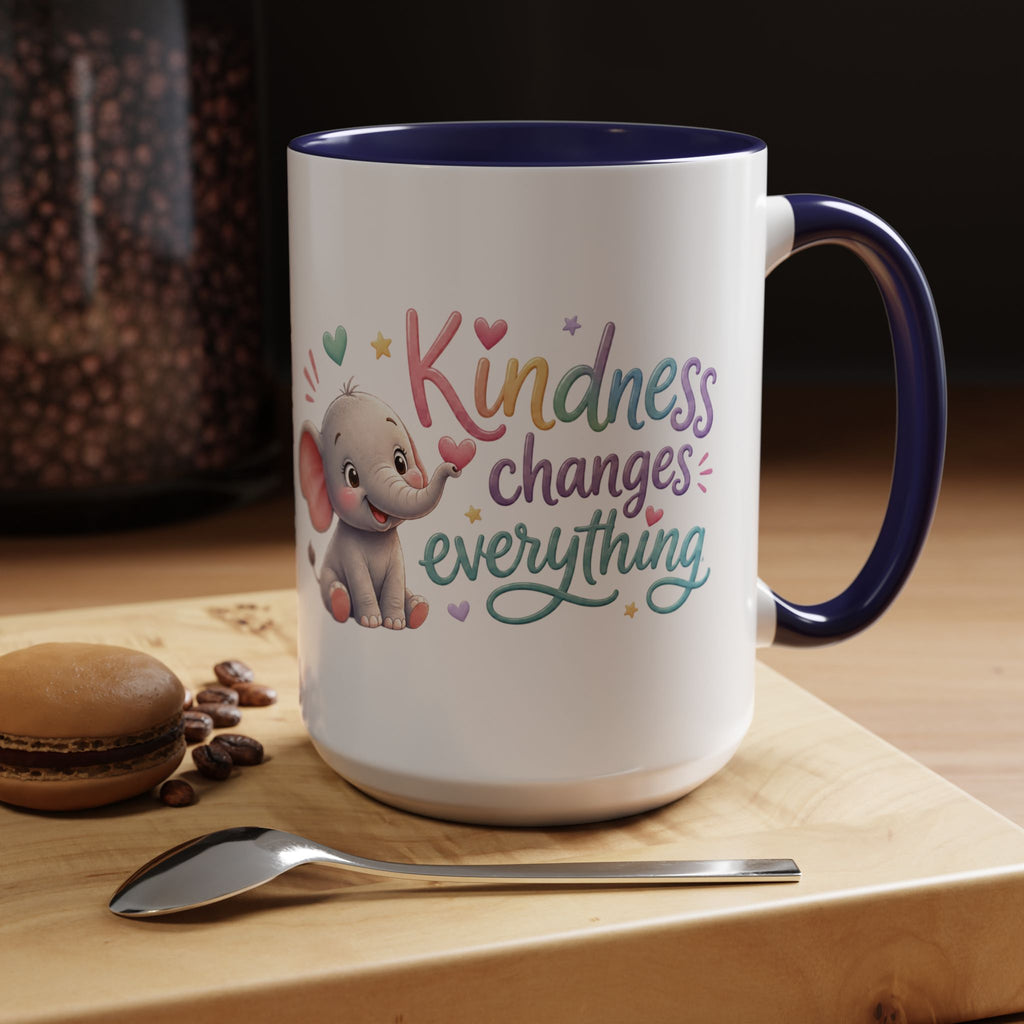 Cute ceramic coffee mug featuring a pastel baby elephant and the uplifting message “Kindness Changes Everything” with colorful accent handle and interior.