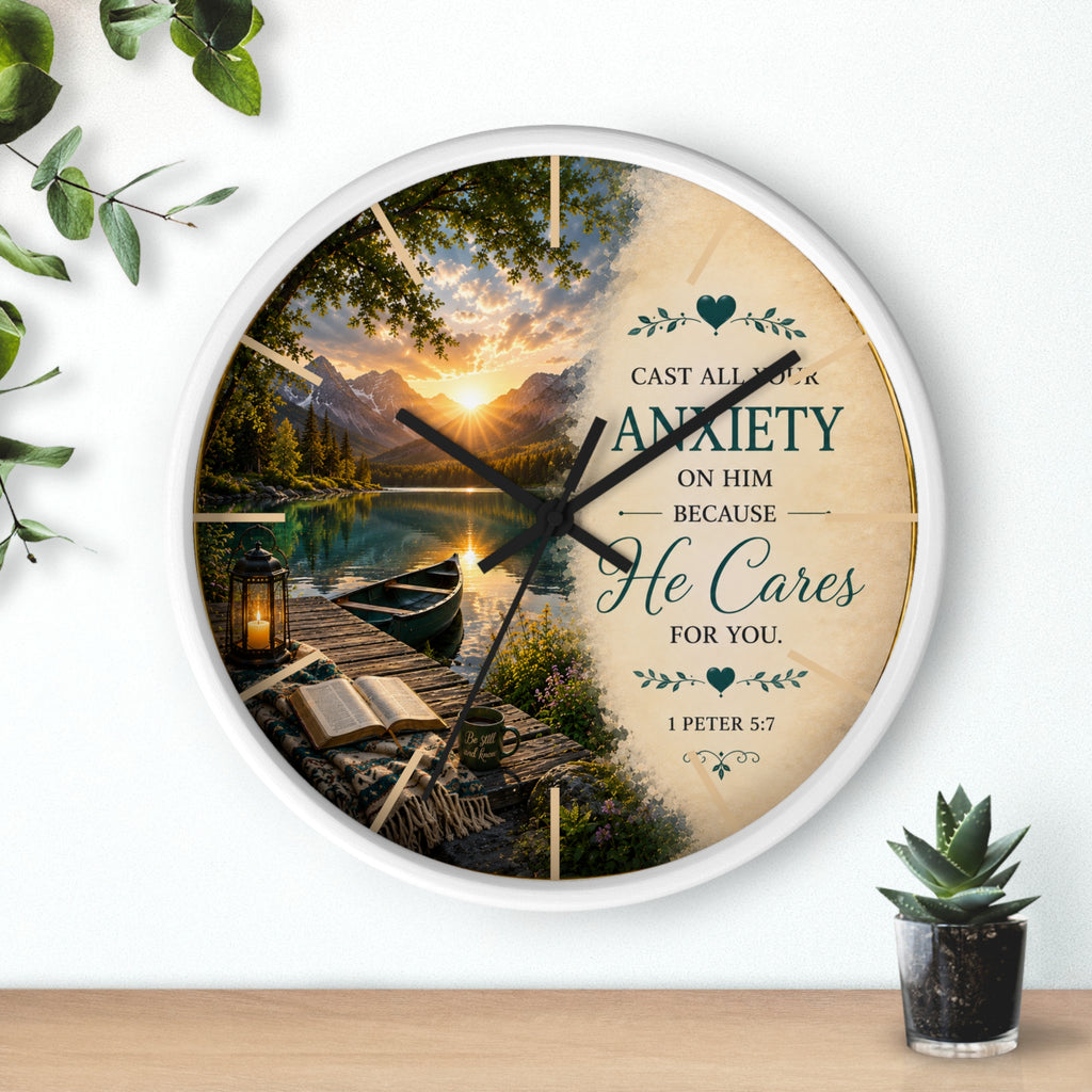 Inspirational Christian wall clock featuring a peaceful lakeside sunrise with a dock, canoe, and 1 Peter 5:7 scripture about casting anxiety on Him.