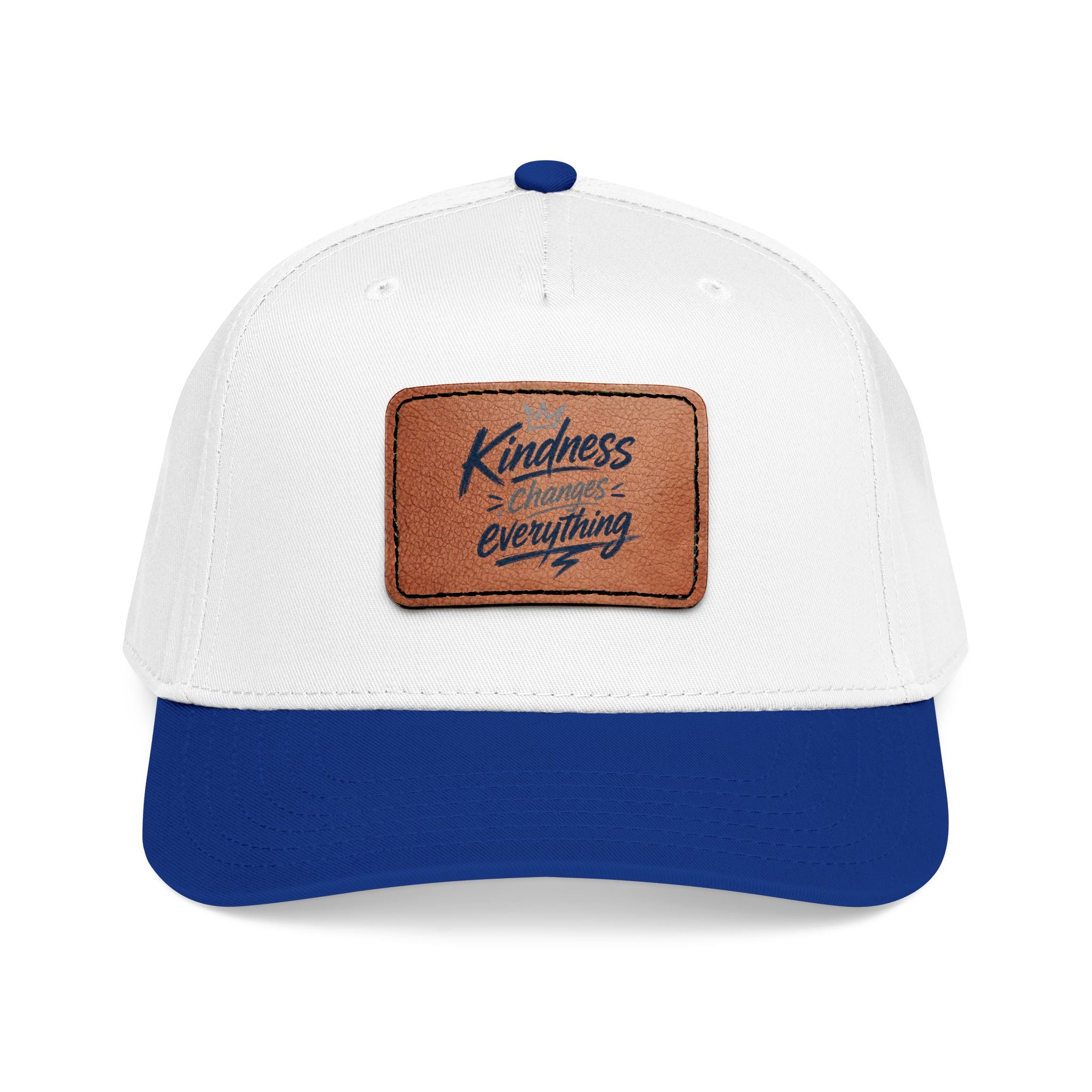 Vintage-inspired baseball cap featuring a brown leather patch with the phrase “Kindness Changes Everything” on a structured mid-profile snapback hat.