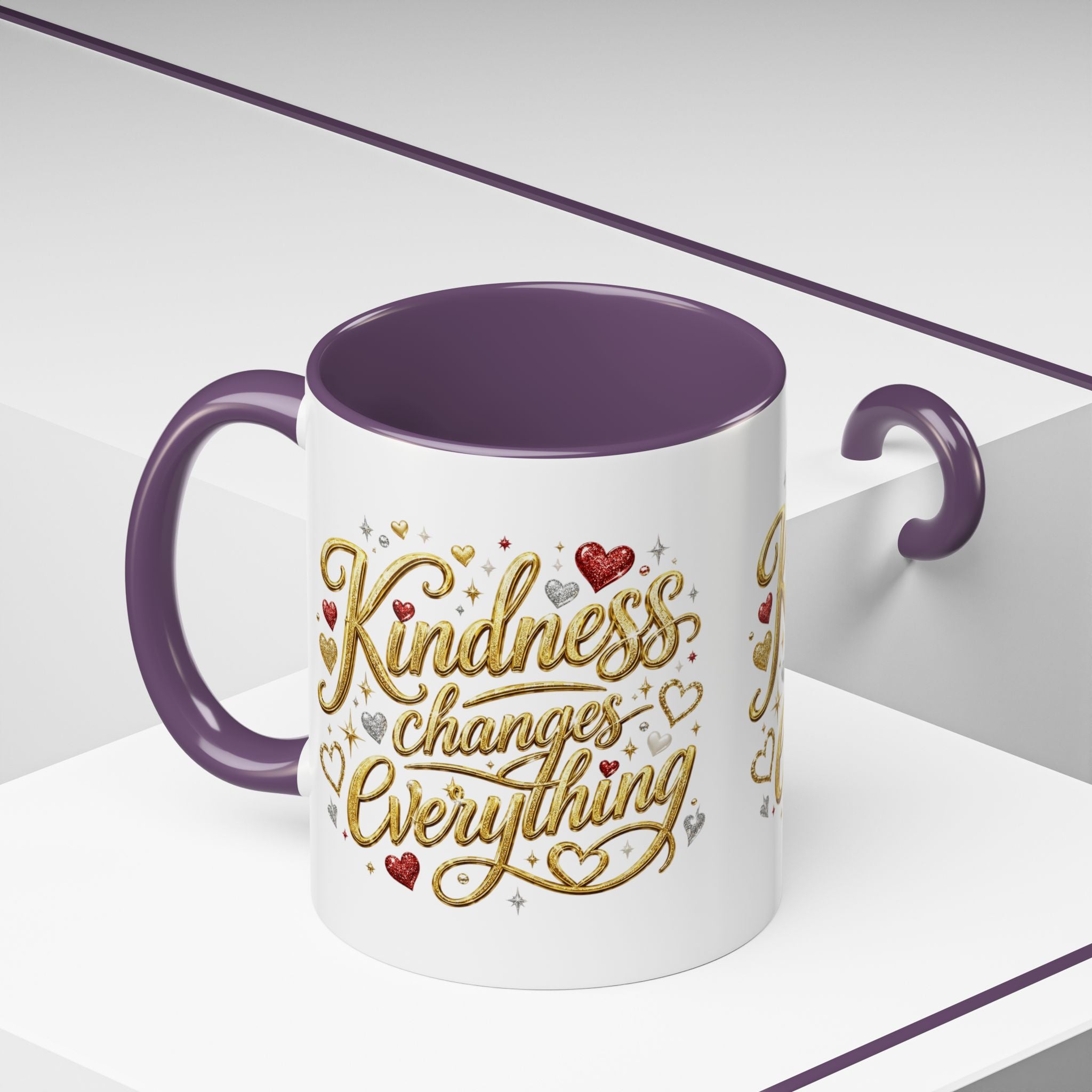 Inspirational ceramic coffee mug featuring the hand-lettered message “Kindness Changes Everything” with gold flourishes, hearts, and colorful accent handle and interior.