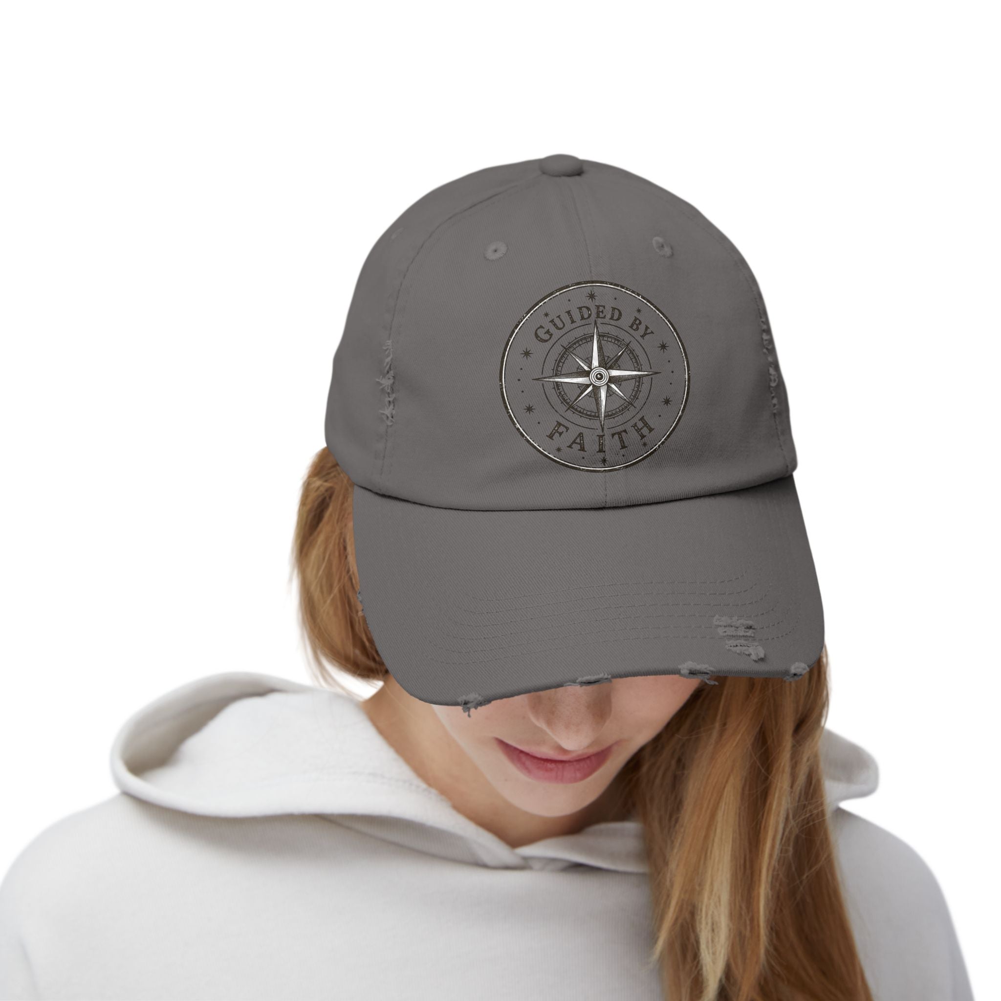Vintage distressed Christian baseball cap featuring a compass emblem and the phrase “Guided by Faith” on a soft low-profile cotton twill hat.