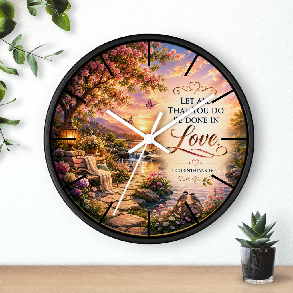 Inspirational Christian wall clock featuring a flower-lined lakeside sunrise scene with 1 Corinthians 16:14 scripture about doing all things in love.