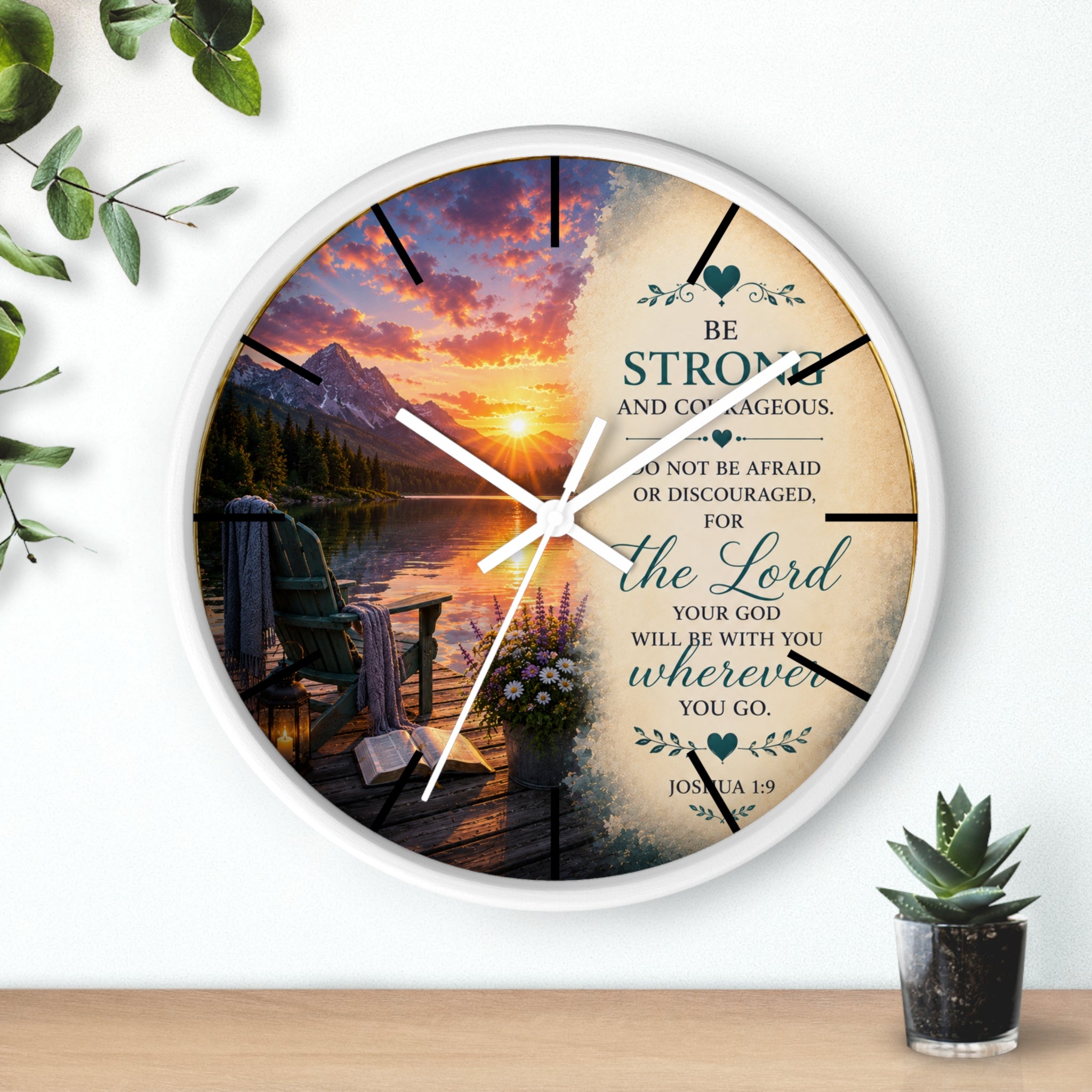 Inspirational Christian wall clock featuring a peaceful lakeside sunrise, mountain scenery, and Joshua 1:9 scripture encouraging strength and courage.
