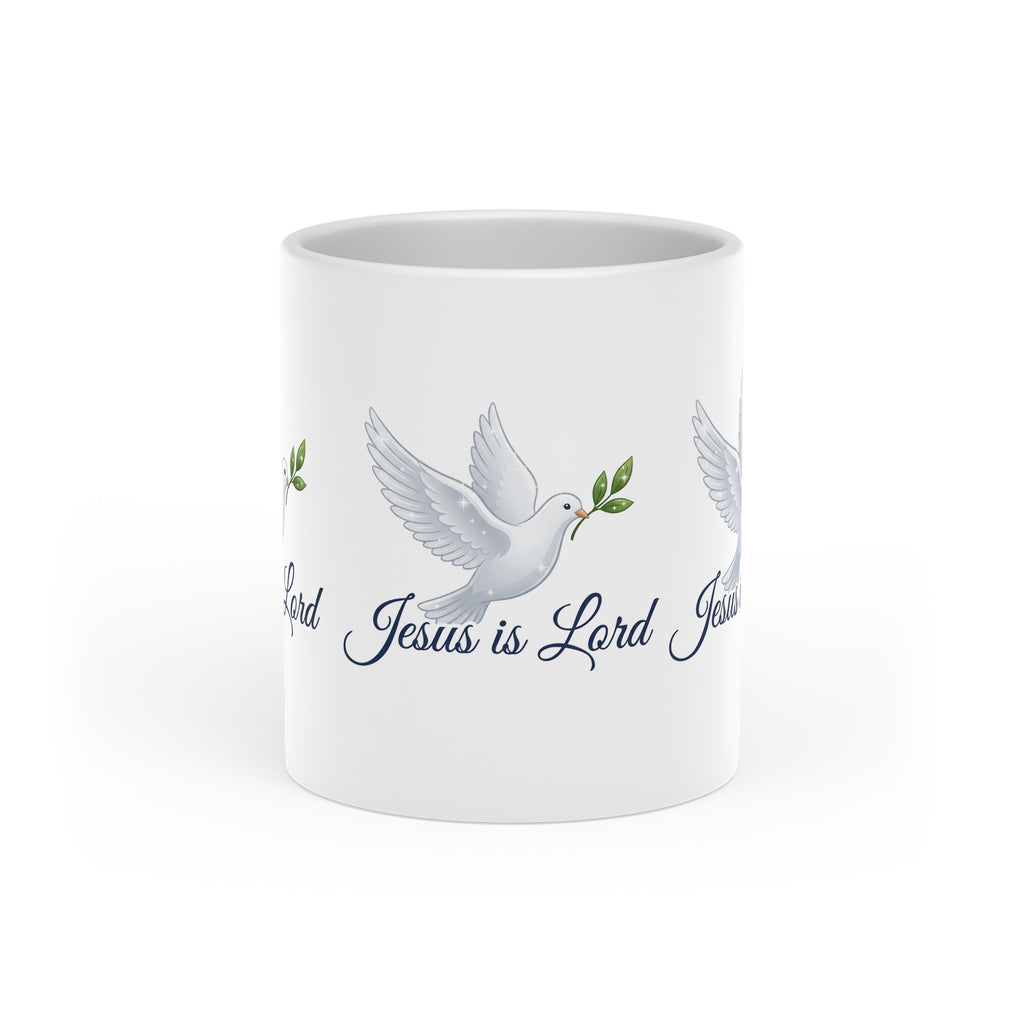 White ceramic heart-shaped handle mug featuring a white dove carrying an olive branch with the words "Jesus Is Lord" in elegant script on a glossy finish.