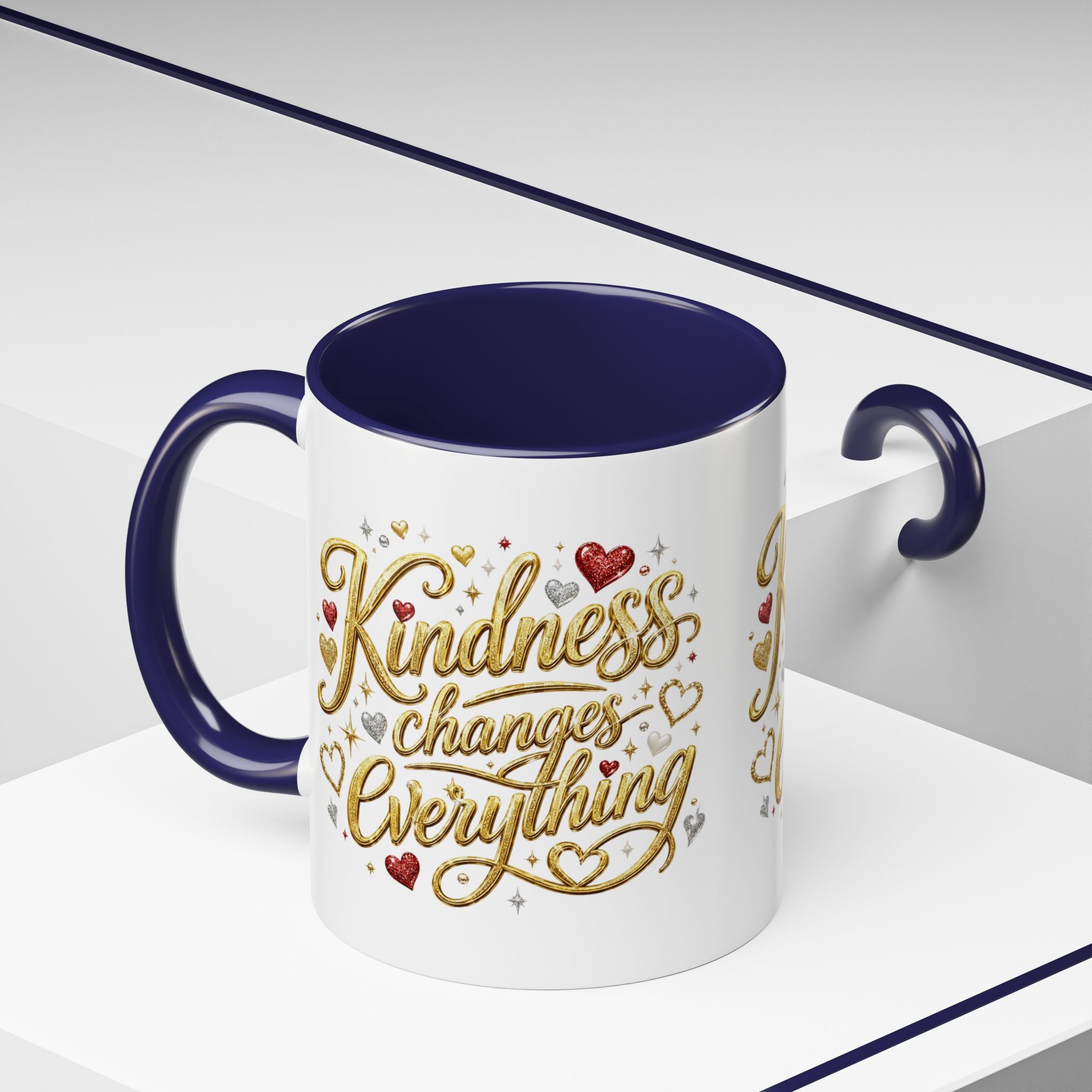 Inspirational ceramic coffee mug featuring the hand-lettered message “Kindness Changes Everything” with gold flourishes, hearts, and colorful accent handle and interior.