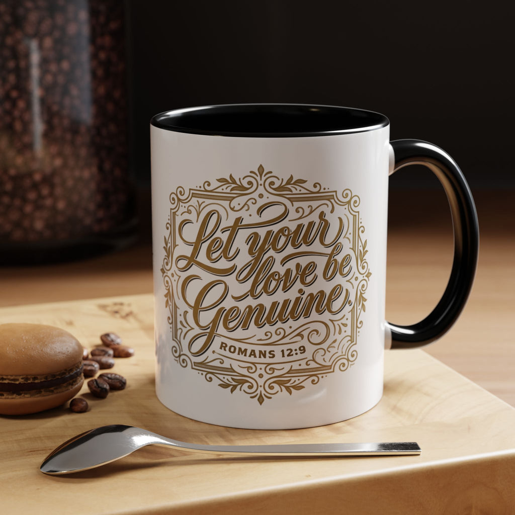 Inspirational ceramic accent coffee mug featuring Romans 12:9 and the message “Let Your Love Be Genuine” in elegant gold script with decorative flourishes and black accent handle and interior.