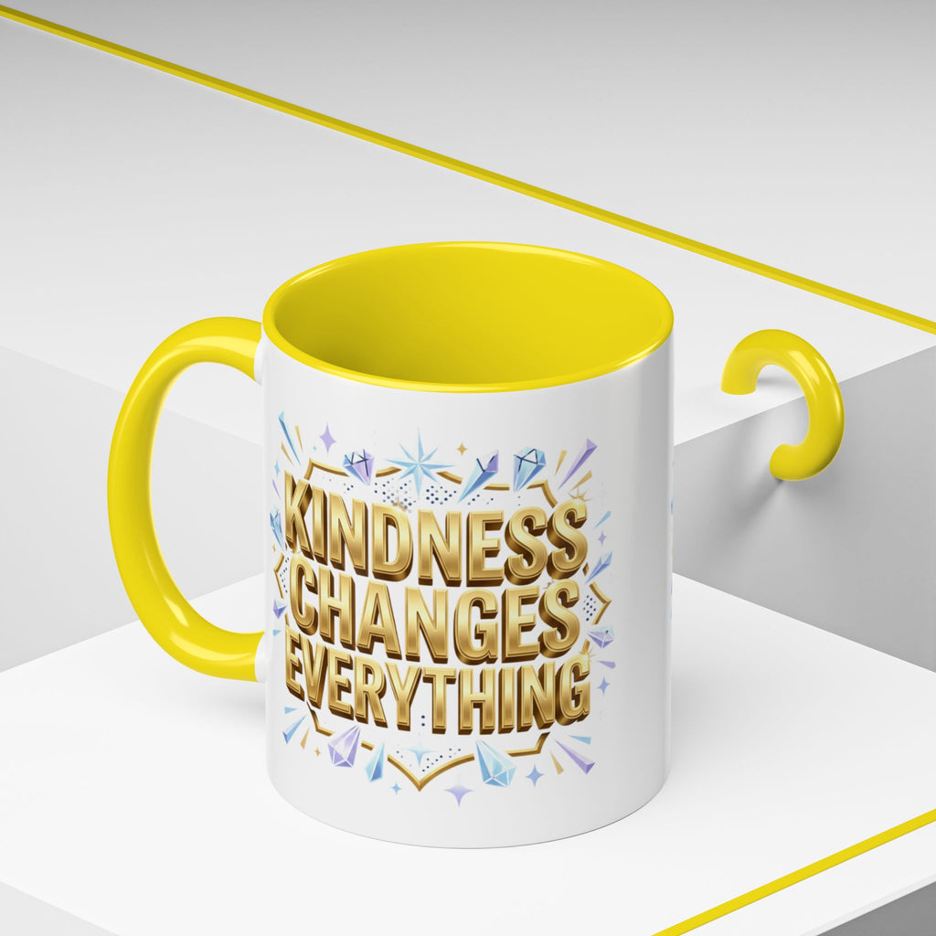 Inspirational ceramic accent coffee mug featuring “Kindness Changes Everything” in elegant gold script with sparkles and colorful accent handle and interior.