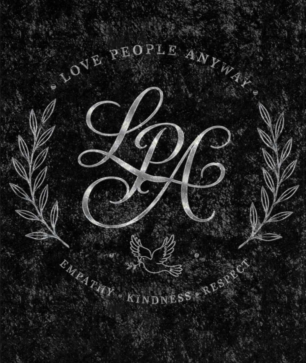 Black crushed velvet blanket featuring a vintage monogram, laurel wreath, and the words "Love People Anyway" in an elegant distressed design.