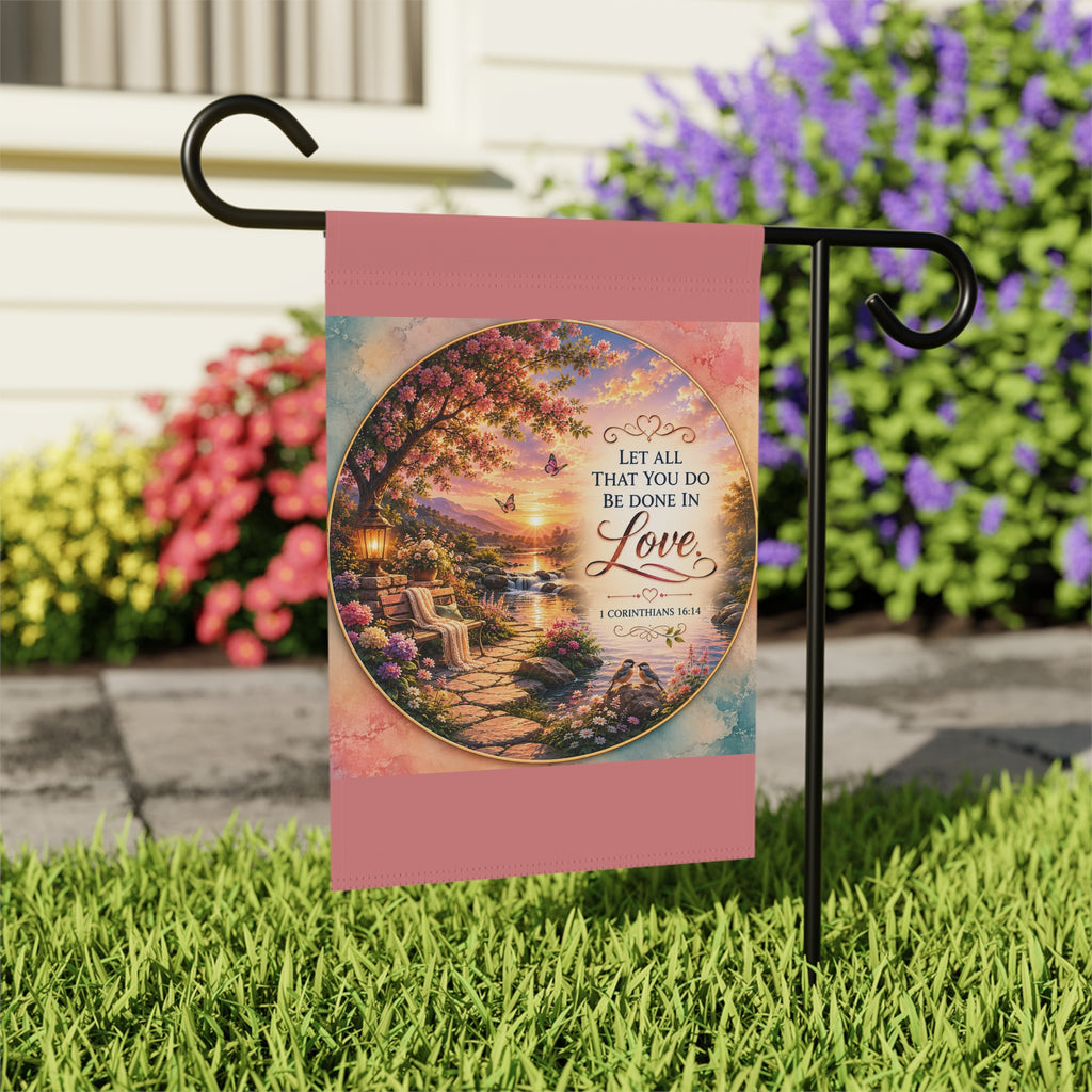 Inspirational Christian garden flag featuring a floral lakeside scene with hydrangeas, a sunlit pathway, and 1 Corinthians 16:14 scripture about love.