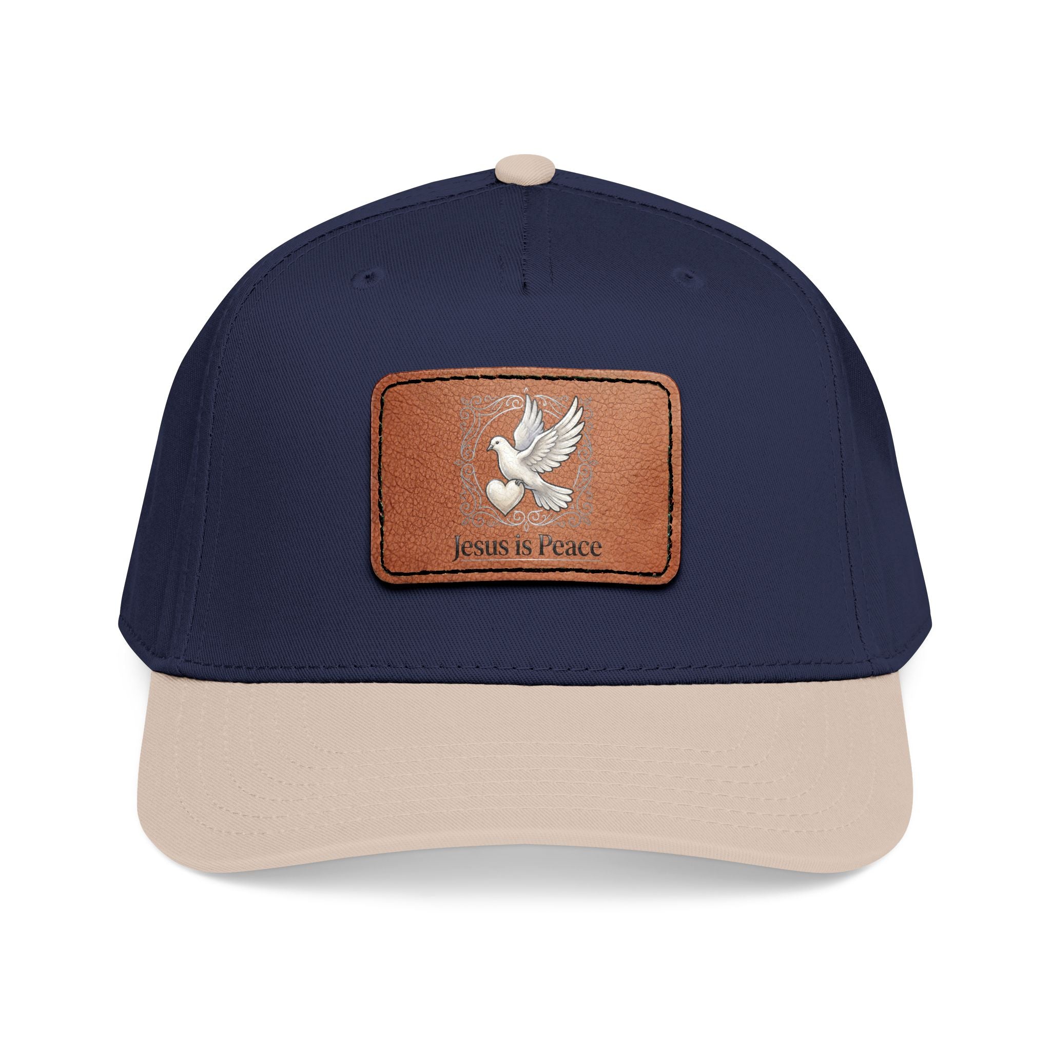 Navy and tan Christian baseball cap featuring a brown leather patch with a white dove carrying a heart and the words "Jesus Is Peace."