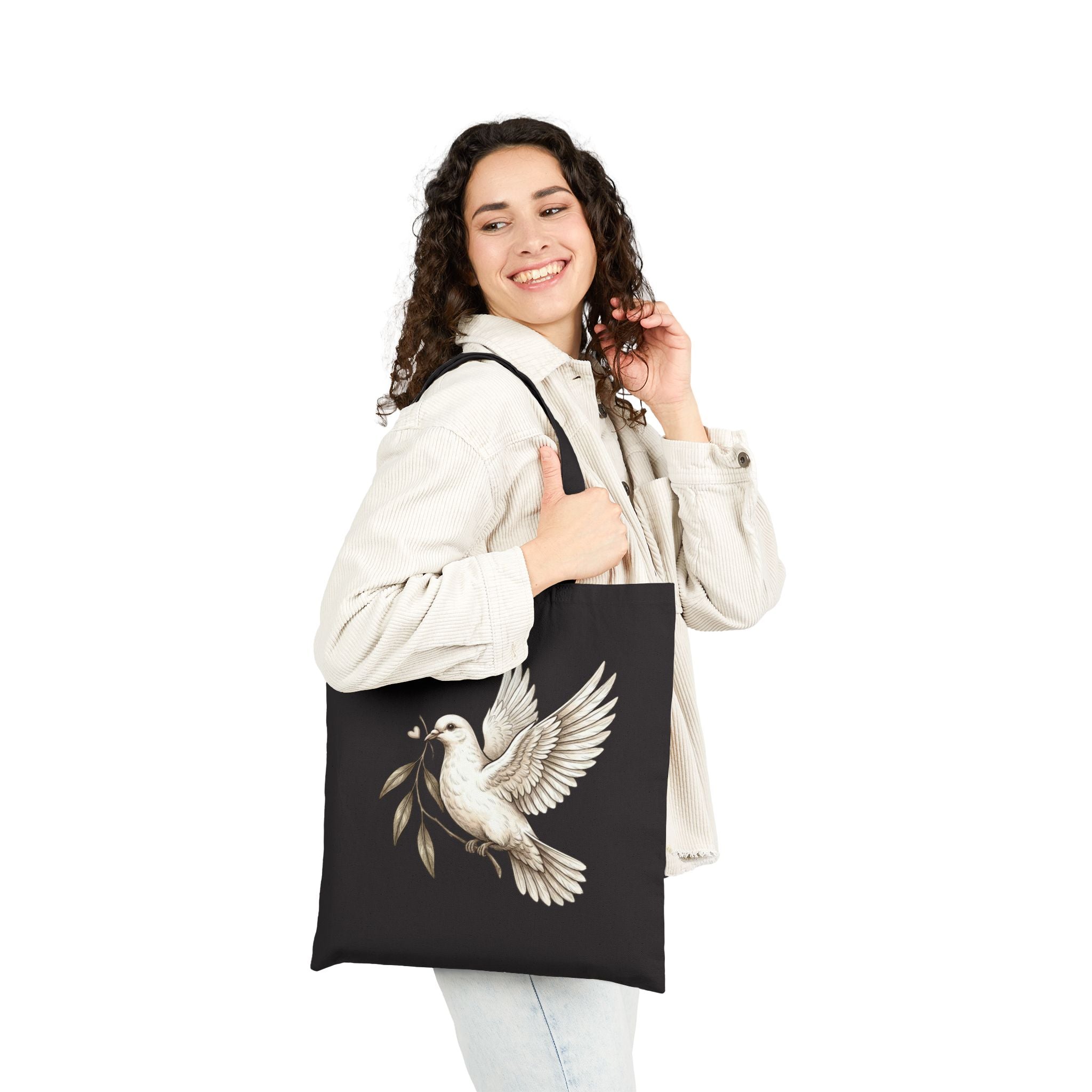 Cotton canvas tote bag featuring a vintage-style dove carrying an olive branch, symbolizing peace, hope, faith, and renewal in a rustic black-and-cream design.