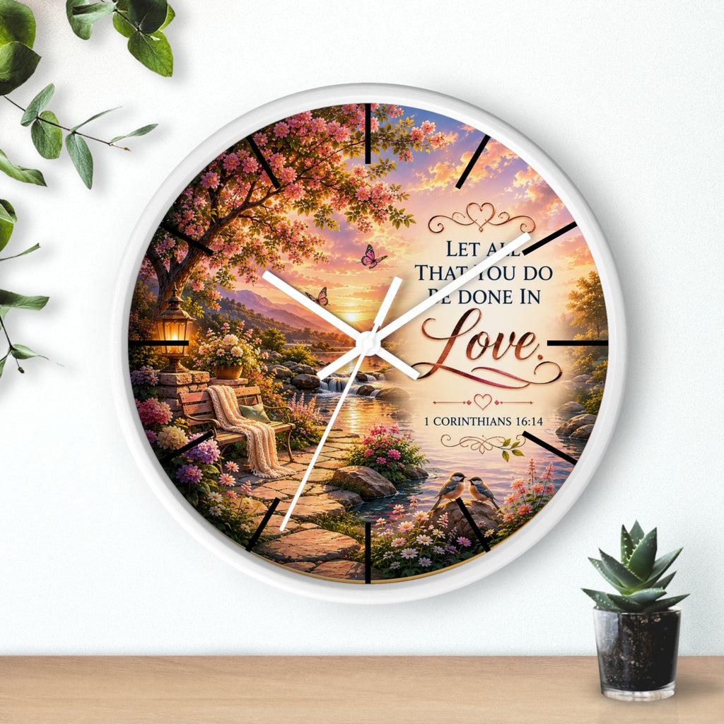 Inspirational Christian wall clock featuring a flower-lined lakeside sunrise scene with 1 Corinthians 16:14 scripture about doing all things in love.