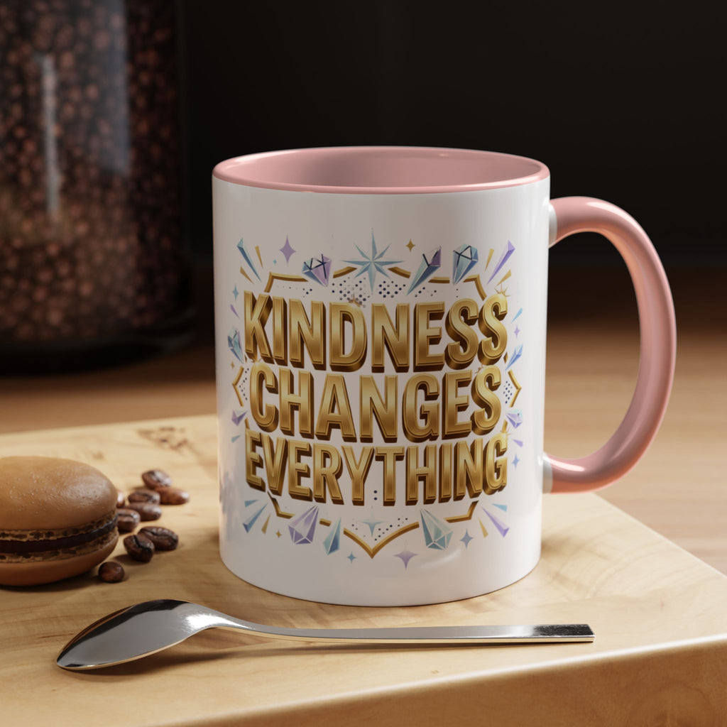 Inspirational ceramic accent coffee mug featuring “Kindness Changes Everything” in elegant gold script with sparkles and colorful accent handle and interior.