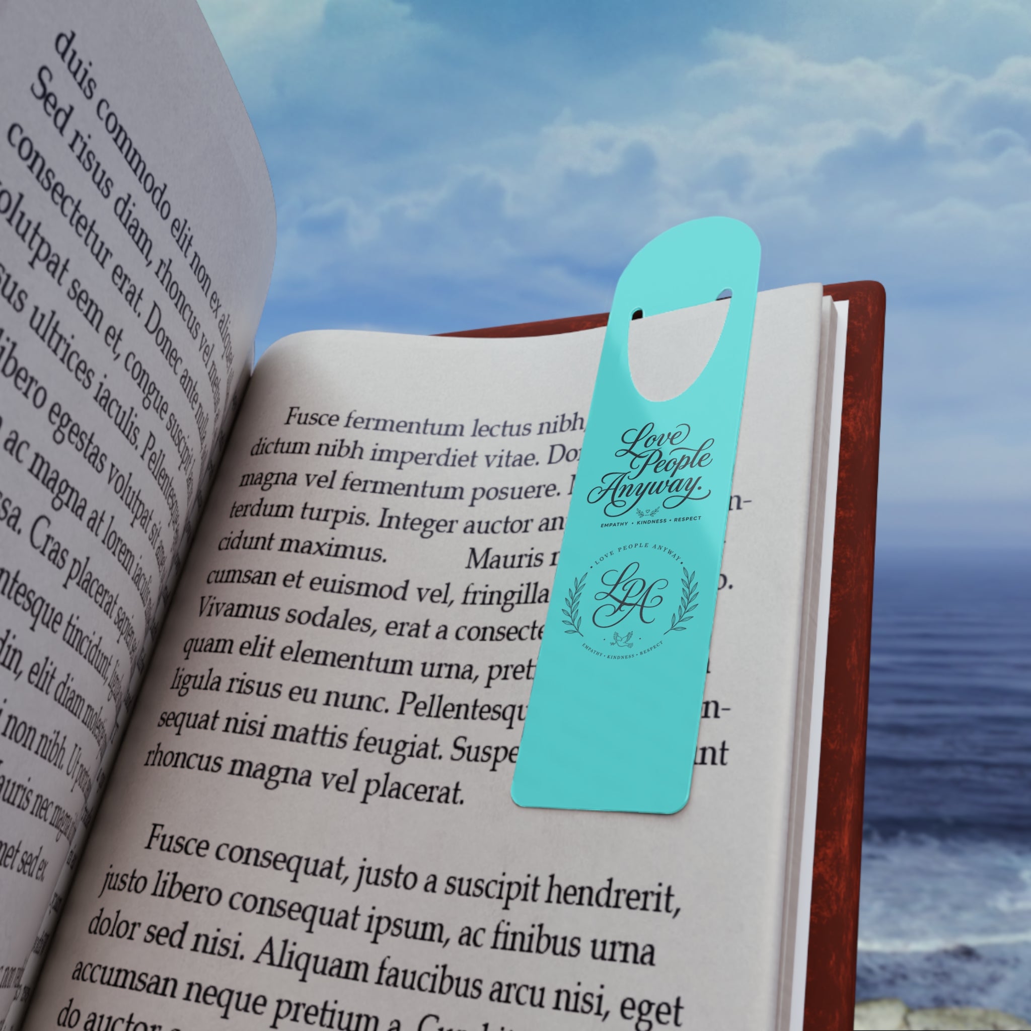 Elegant aluminum bookmark featuring a laurel wreath LGA monogram and “Love People Anyway” message with brushed metal backing and secure page-holding slot for books, journals, and devotionals.