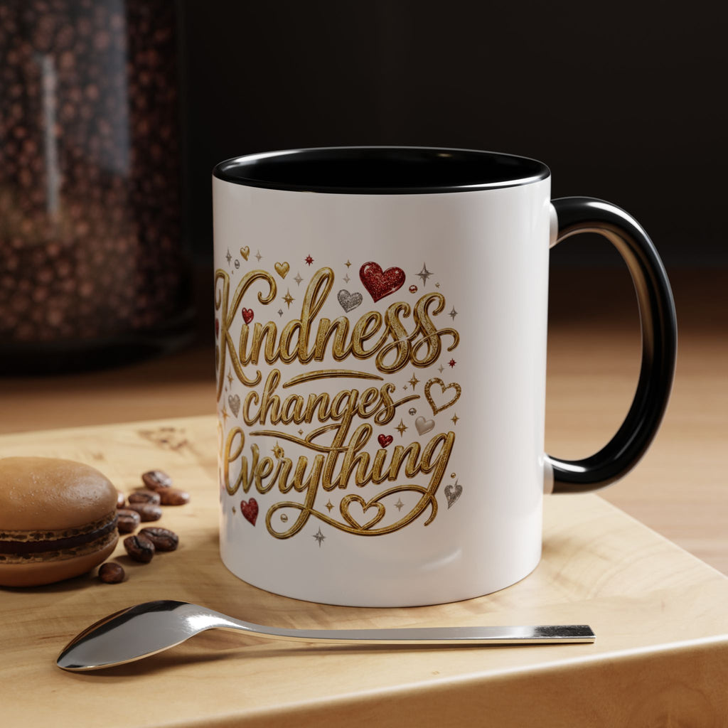 Inspirational ceramic coffee mug featuring the hand-lettered message “Kindness Changes Everything” with gold flourishes, hearts, and colorful accent handle and interior.