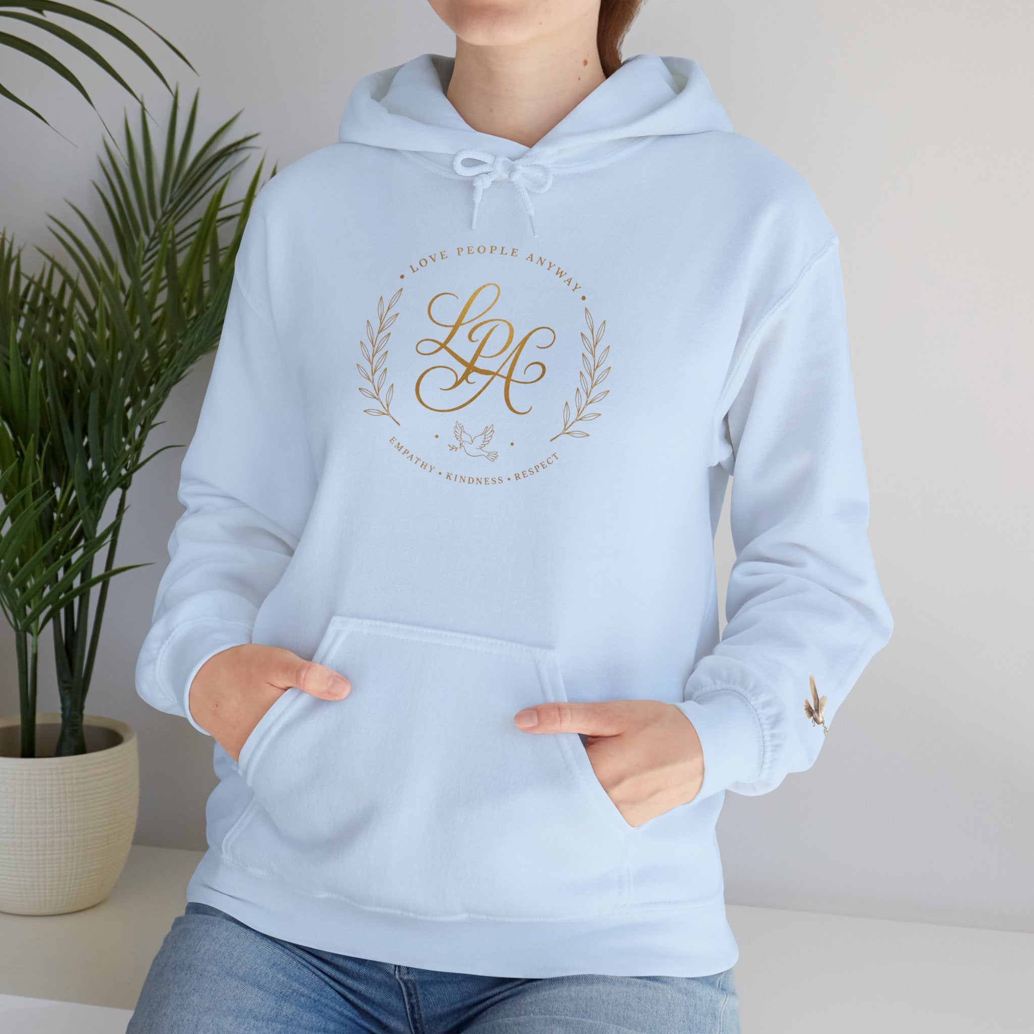 Inspirational Christian hoodie featuring elegant “Love People Anyway” script typography on a soft, cozy hooded sweatshirt designed to encourage kindness and compassion.