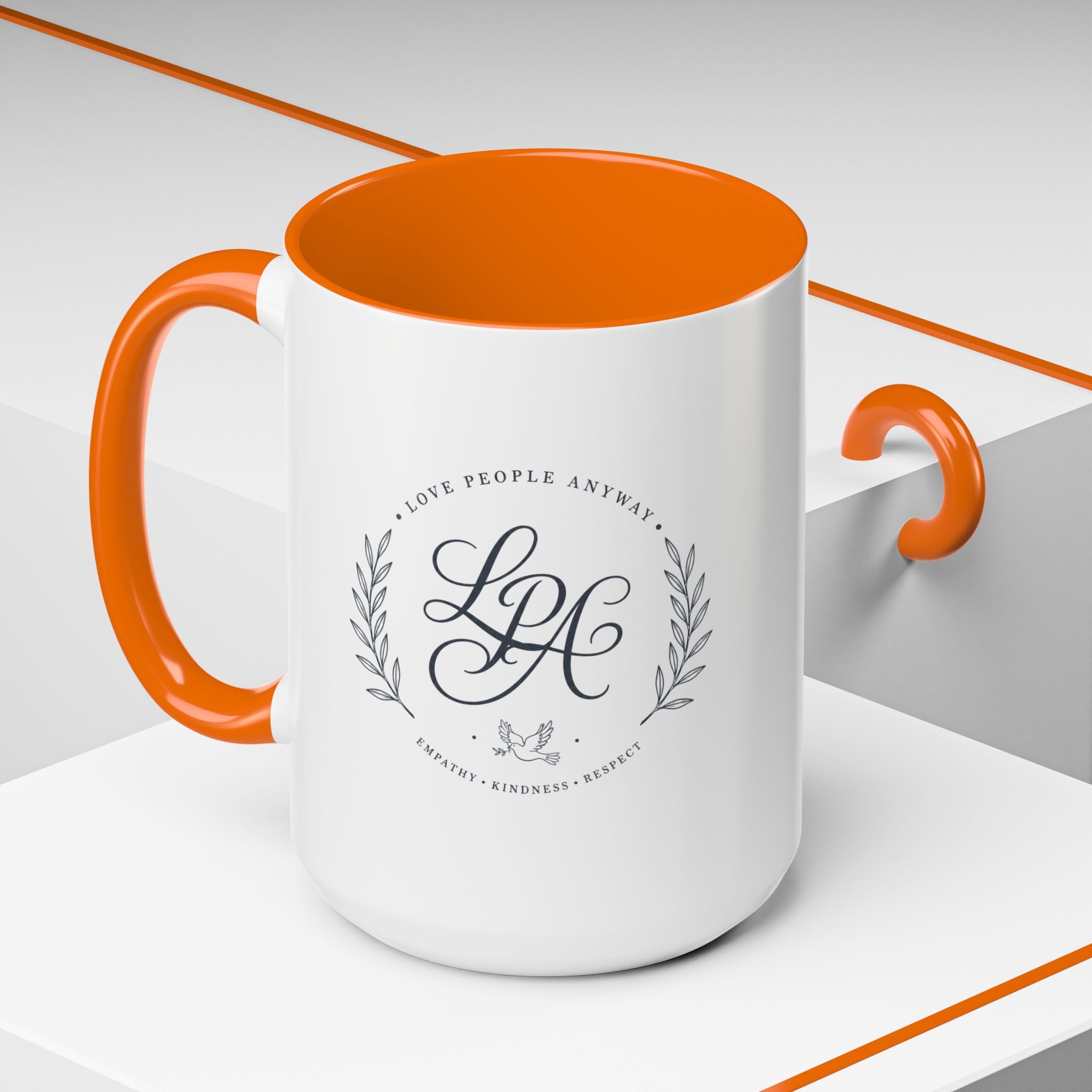 Personalized ceramic accent coffee mug featuring a custom monogram crest and the inspirational message “Love People Anyway” with colorful handle and interior accents.
