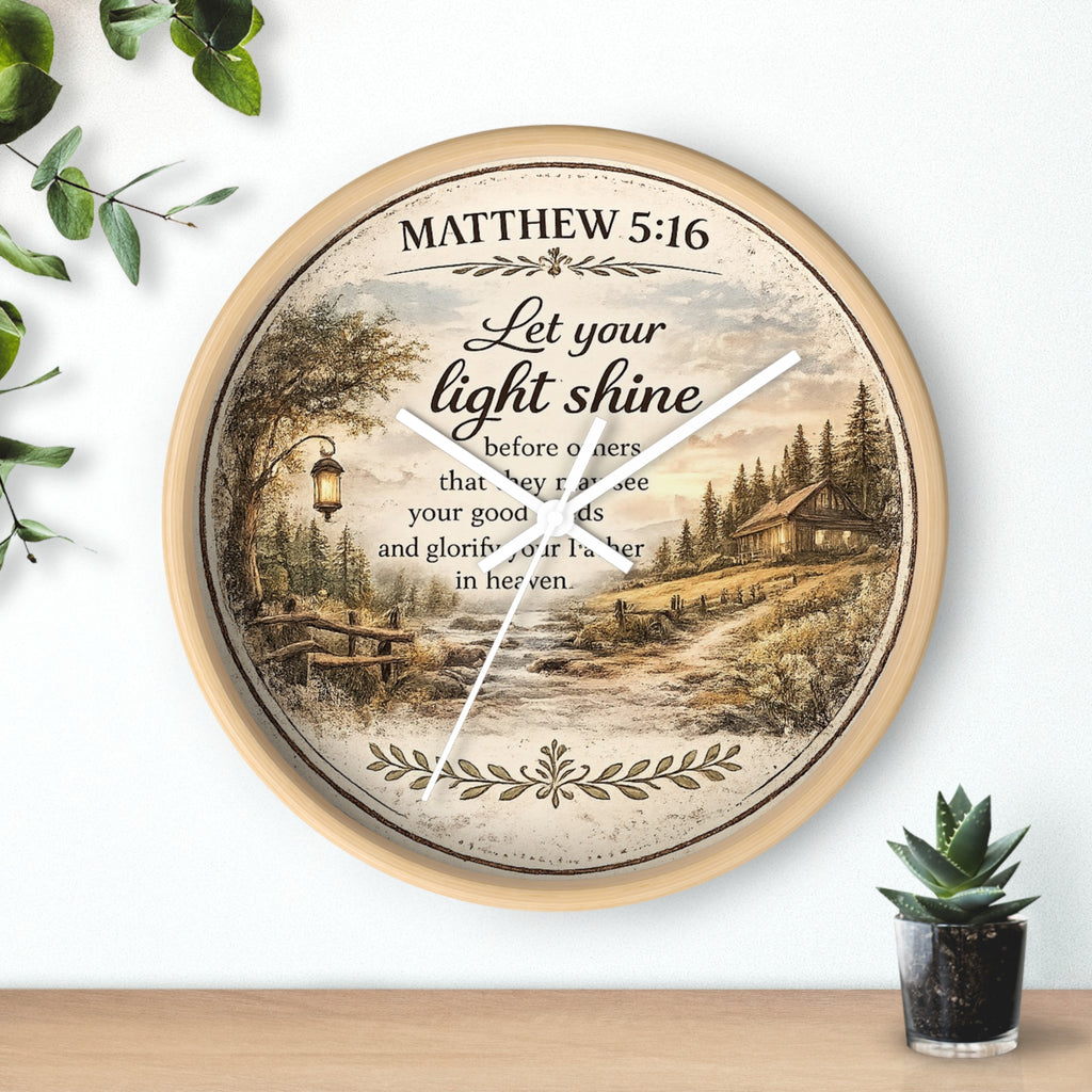 Inspirational Christian wall clock featuring Matthew 5:16 with a lantern-lit path, pine trees, rustic cottage, and warm countryside artwork in vintage farmhouse style.