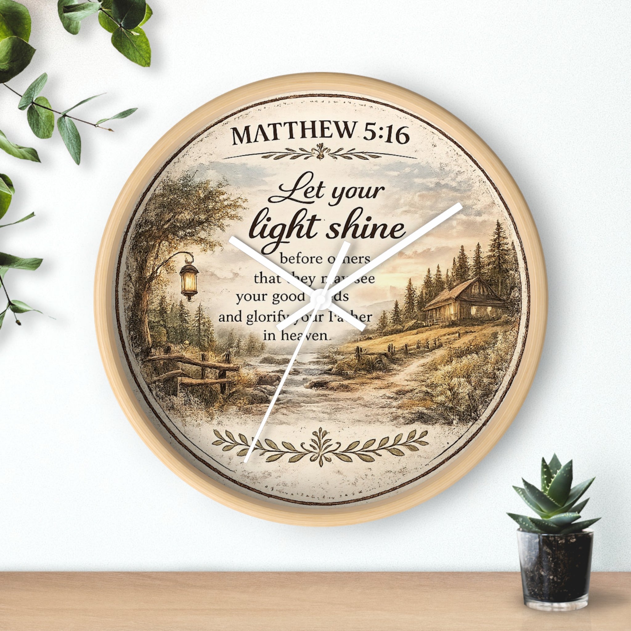 Inspirational Christian wall clock featuring Matthew 5:16 with a lantern-lit path, pine trees, rustic cottage, and warm countryside artwork in vintage farmhouse style.