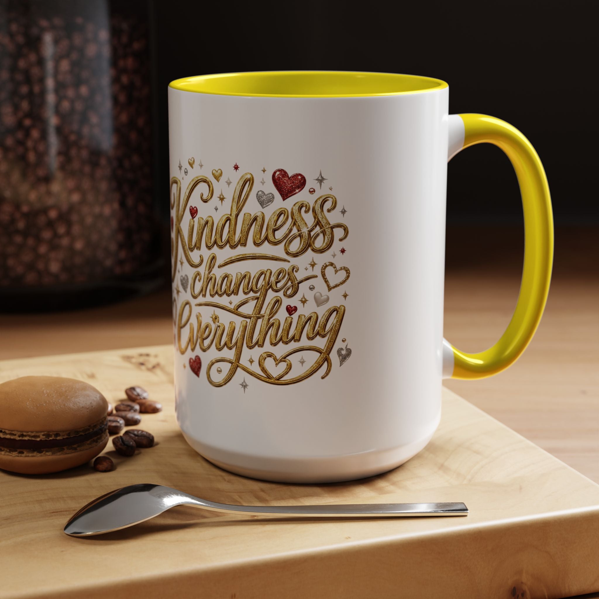 Inspirational ceramic coffee mug featuring the hand-lettered message “Kindness Changes Everything” with gold flourishes, hearts, and colorful accent handle and interior.