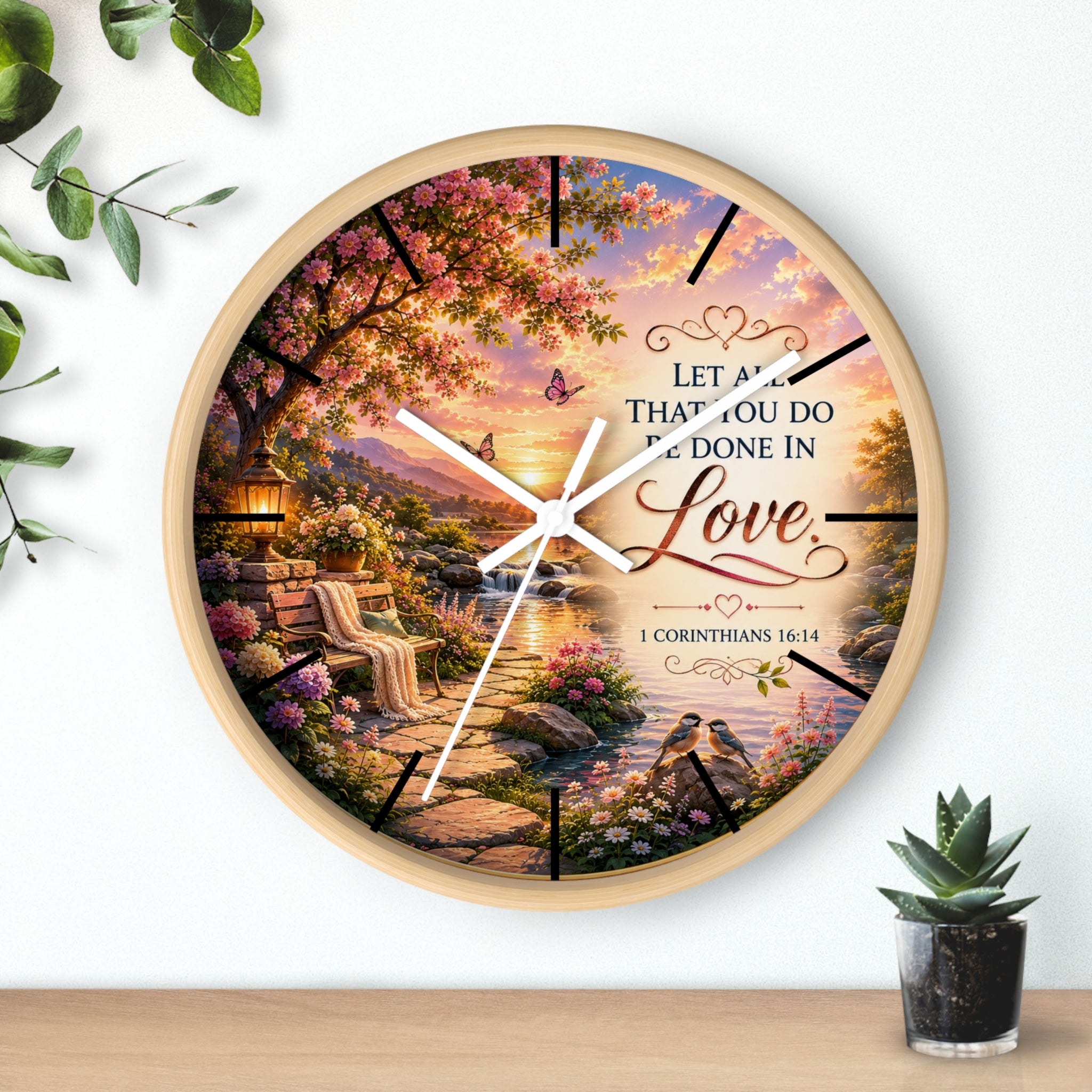 Inspirational Christian wall clock featuring a flower-lined lakeside sunrise scene with 1 Corinthians 16:14 scripture about doing all things in love.