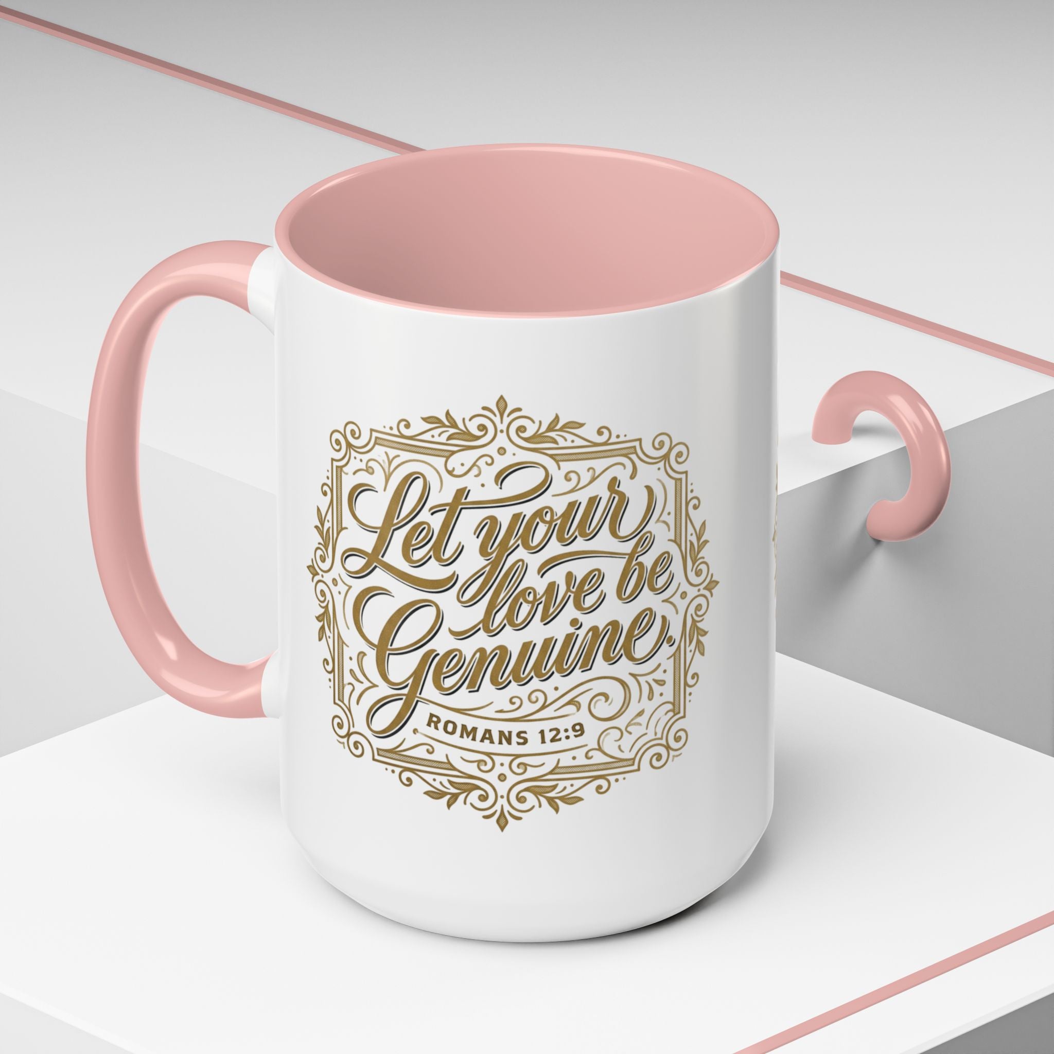 Inspirational ceramic accent coffee mug featuring Romans 12:9 and the message “Let Your Love Be Genuine” in elegant gold script with decorative flourishes and black accent handle and interior.