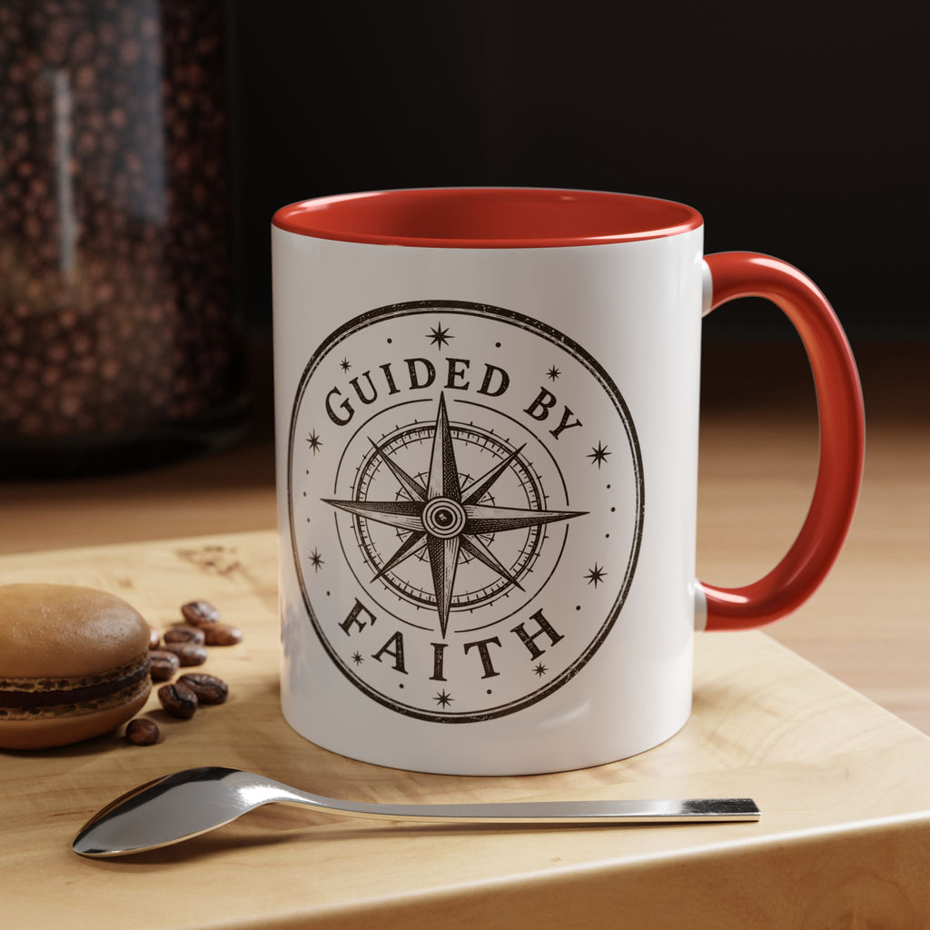 Inspirational ceramic accent coffee mug featuring a compass design and “Guided by Faith” message with colorful handle and interior accents on a glossy white mug.