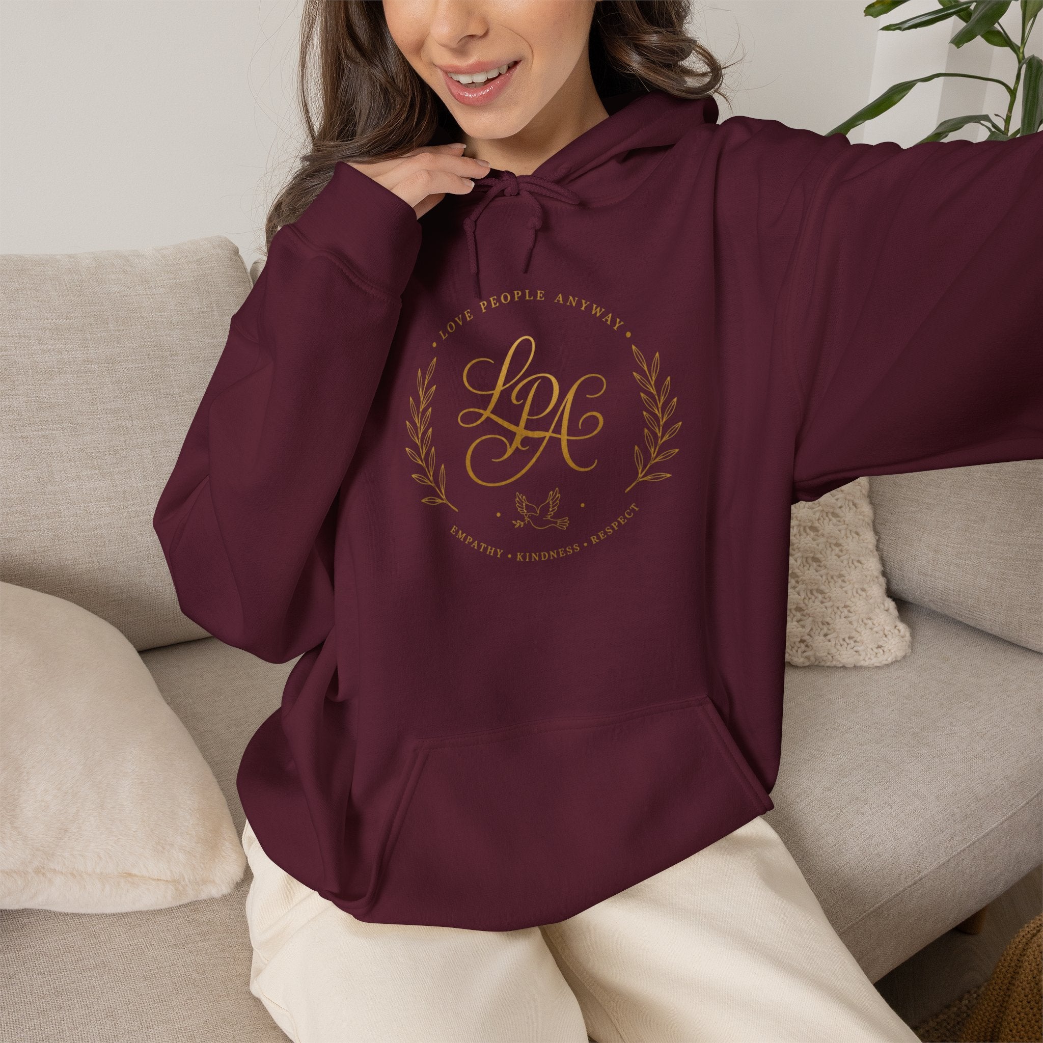 Inspirational Christian hoodie featuring elegant “Love People Anyway” script typography on a soft, cozy hooded sweatshirt designed to encourage kindness and compassion.