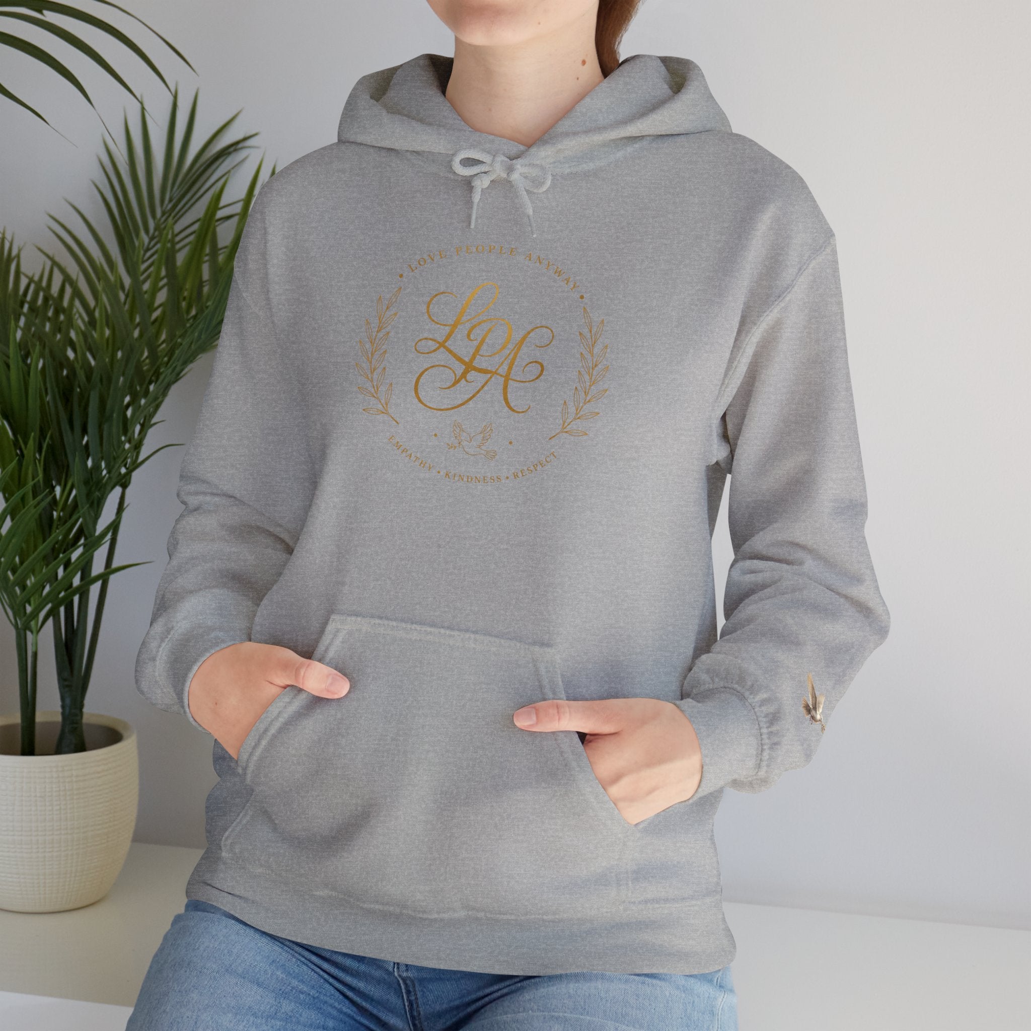 Inspirational Christian hoodie featuring elegant “Love People Anyway” script typography on a soft, cozy hooded sweatshirt designed to encourage kindness and compassion.