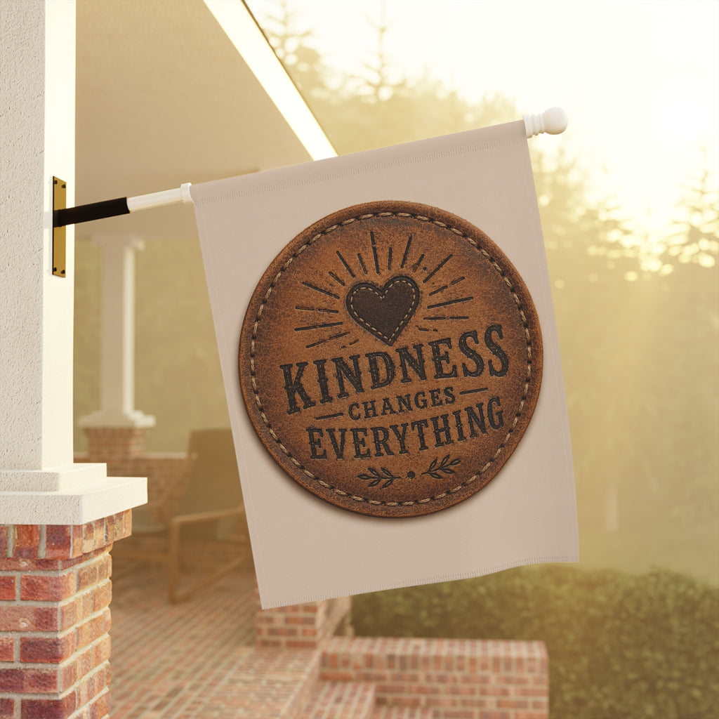 Inspirational garden flag featuring a rustic stitched leather-look medallion design with the message “Kindness Changes Everything” on a neutral farmhouse-style outdoor banner.