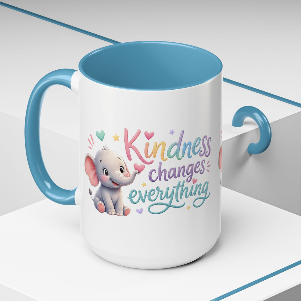 Cute ceramic coffee mug featuring a pastel baby elephant and the uplifting message “Kindness Changes Everything” with colorful accent handle and interior.