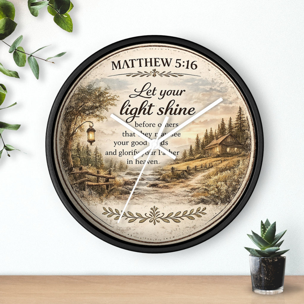 Inspirational Christian wall clock featuring Matthew 5:16 with a lantern-lit path, pine trees, rustic cottage, and warm countryside artwork in vintage farmhouse style.