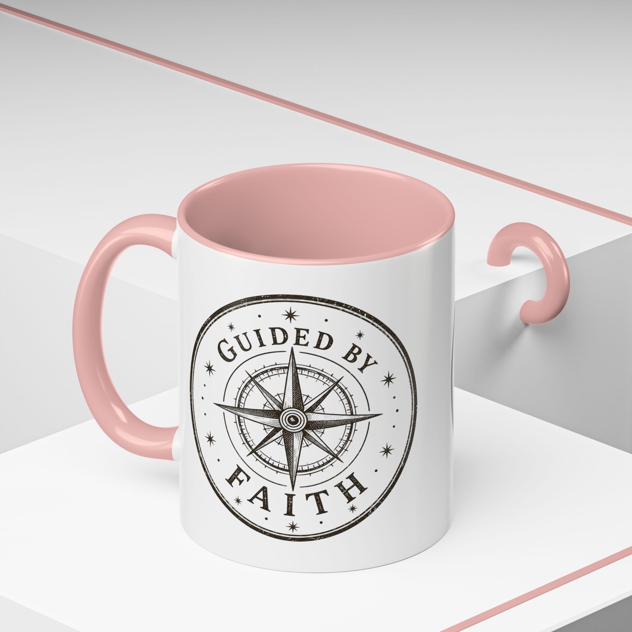 Inspirational ceramic accent coffee mug featuring a compass design and “Guided by Faith” message with colorful handle and interior accents on a glossy white mug.