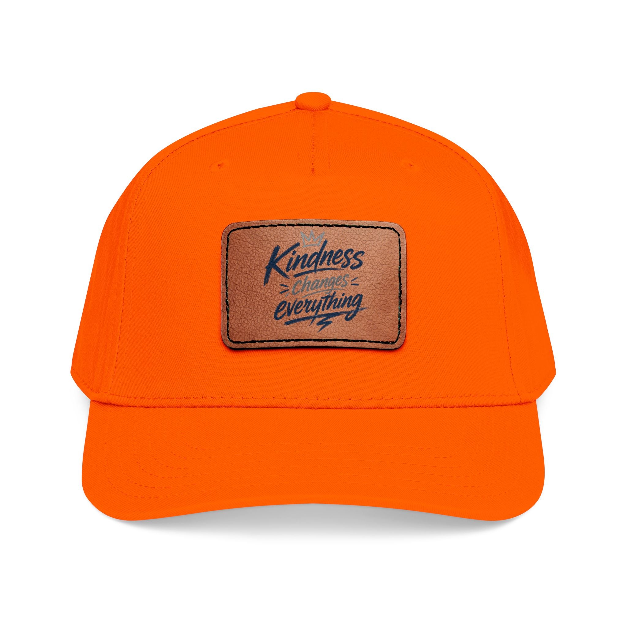 Vintage-inspired baseball cap featuring a brown leather patch with the phrase “Kindness Changes Everything” on a structured mid-profile snapback hat.
