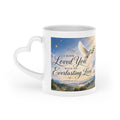 White ceramic heart-shaped handle mug featuring peaceful white doves over rolling hills with the Scripture "I have loved you with an everlasting love" from Jeremiah 31:3.