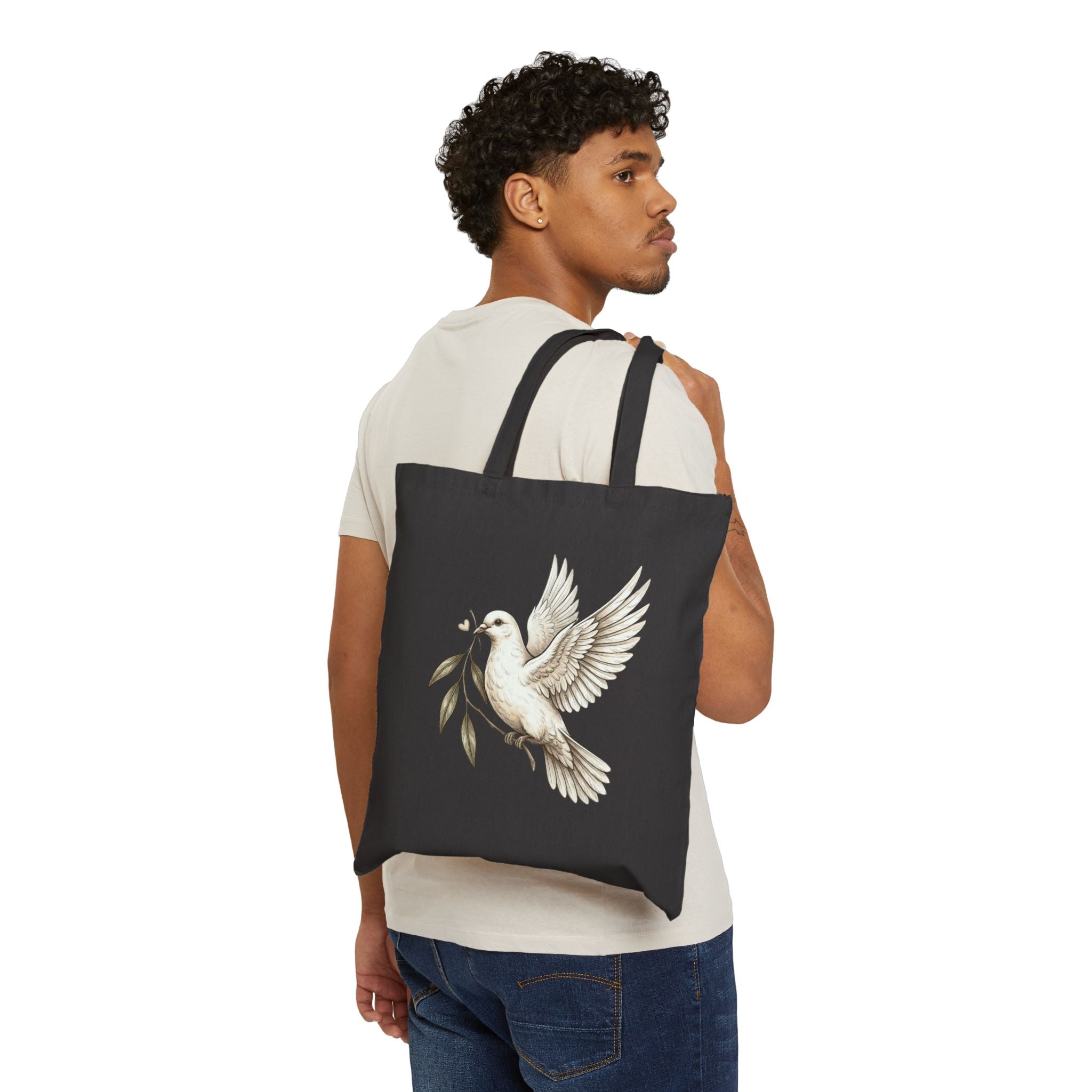 Cotton canvas tote bag featuring a vintage-style dove carrying an olive branch, symbolizing peace, hope, faith, and renewal in a rustic black-and-cream design.