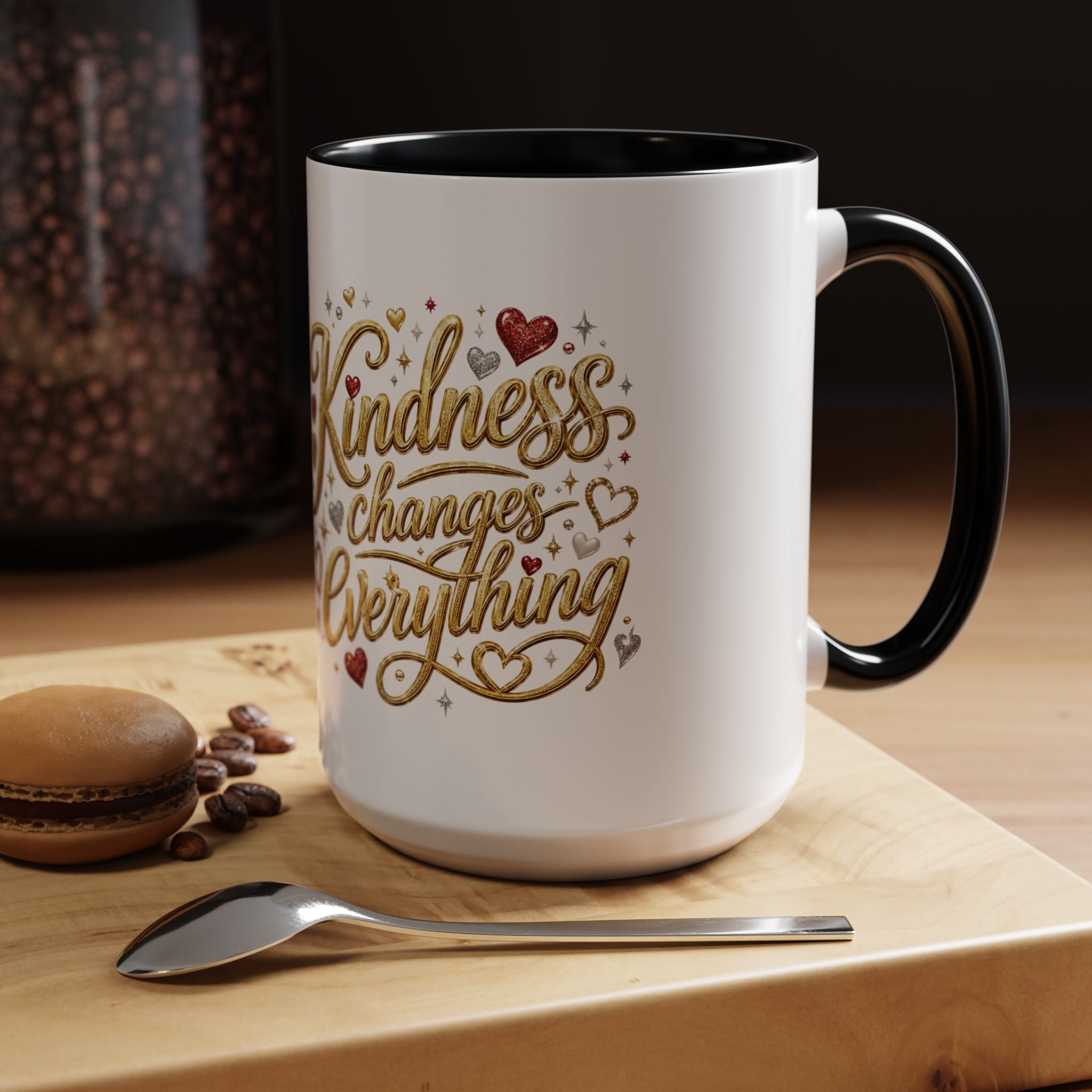 Inspirational ceramic coffee mug featuring the hand-lettered message “Kindness Changes Everything” with gold flourishes, hearts, and colorful accent handle and interior.