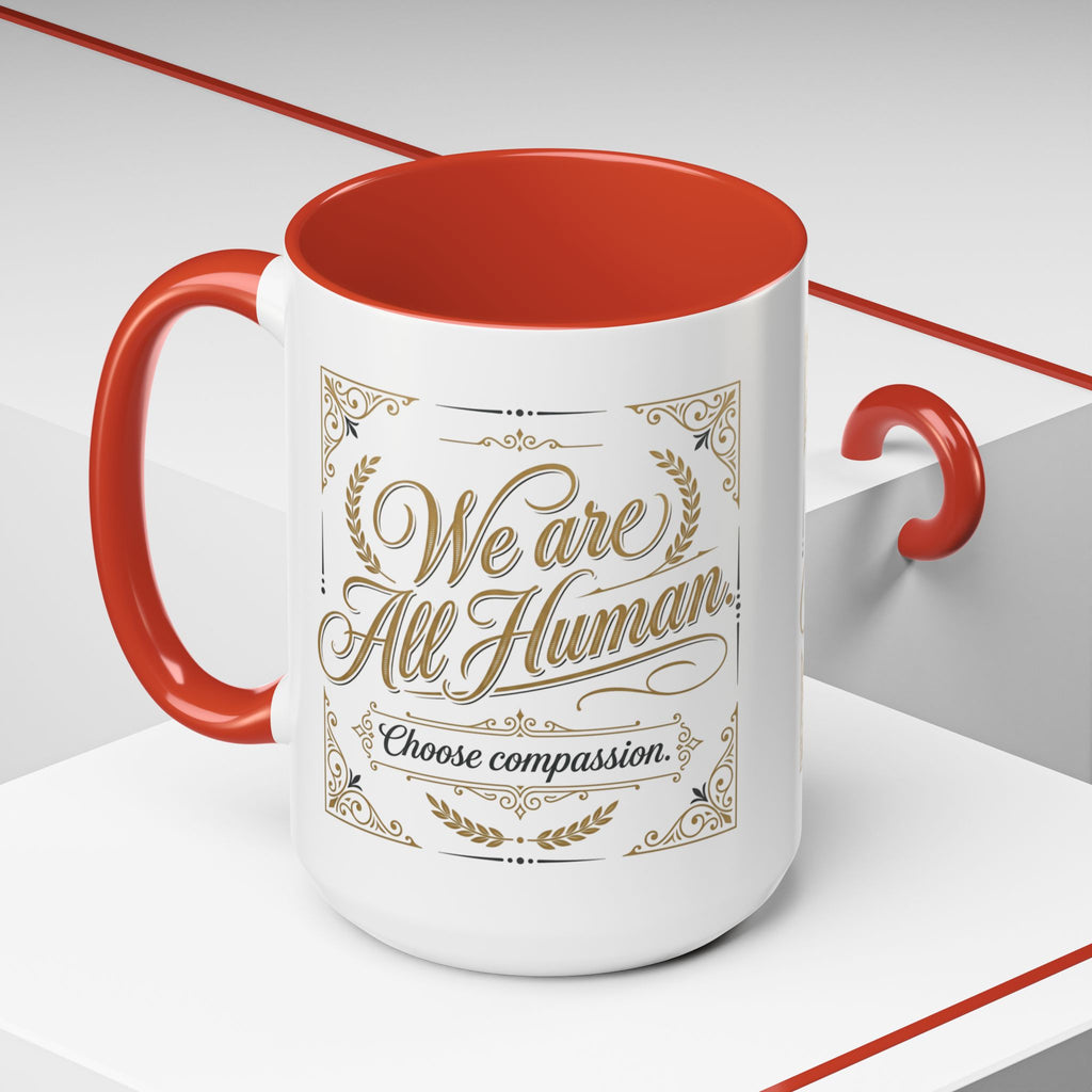 Inspirational ceramic accent coffee mug featuring “We Are All Human – Choose Compassion” in vintage-style gold lettering with decorative flourishes and black accent handle and interior.