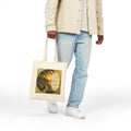 Christian cotton canvas tote bag featuring Matthew 11:28, “Come to Me, all you who are weary and burdened, and I will give you rest,” with peaceful garden pathway, glowing lanterns, riverside cottages, blooming flowers, and sunset artwork.