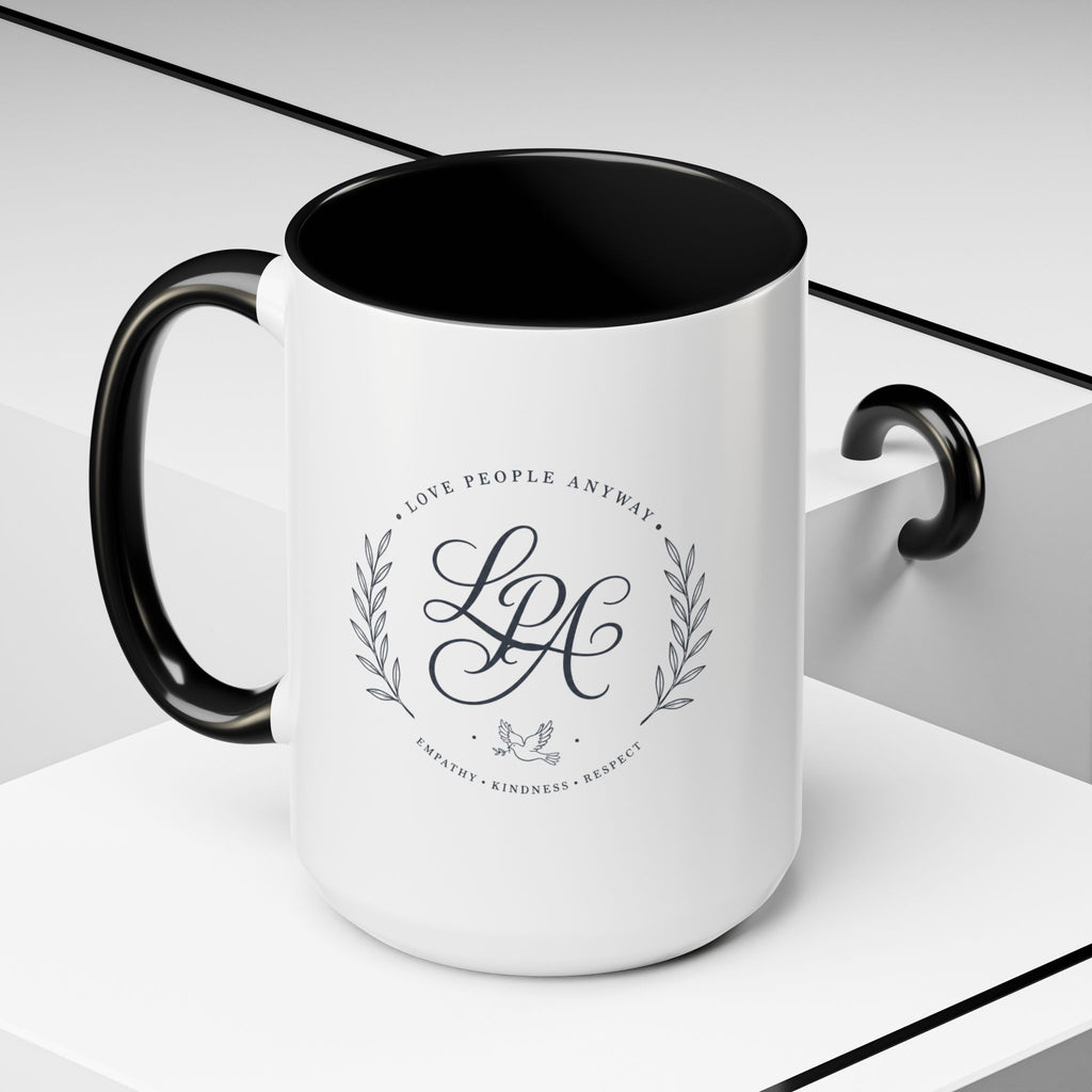 Personalized ceramic accent coffee mug featuring a custom monogram crest and the inspirational message “Love People Anyway” with colorful handle and interior accents.