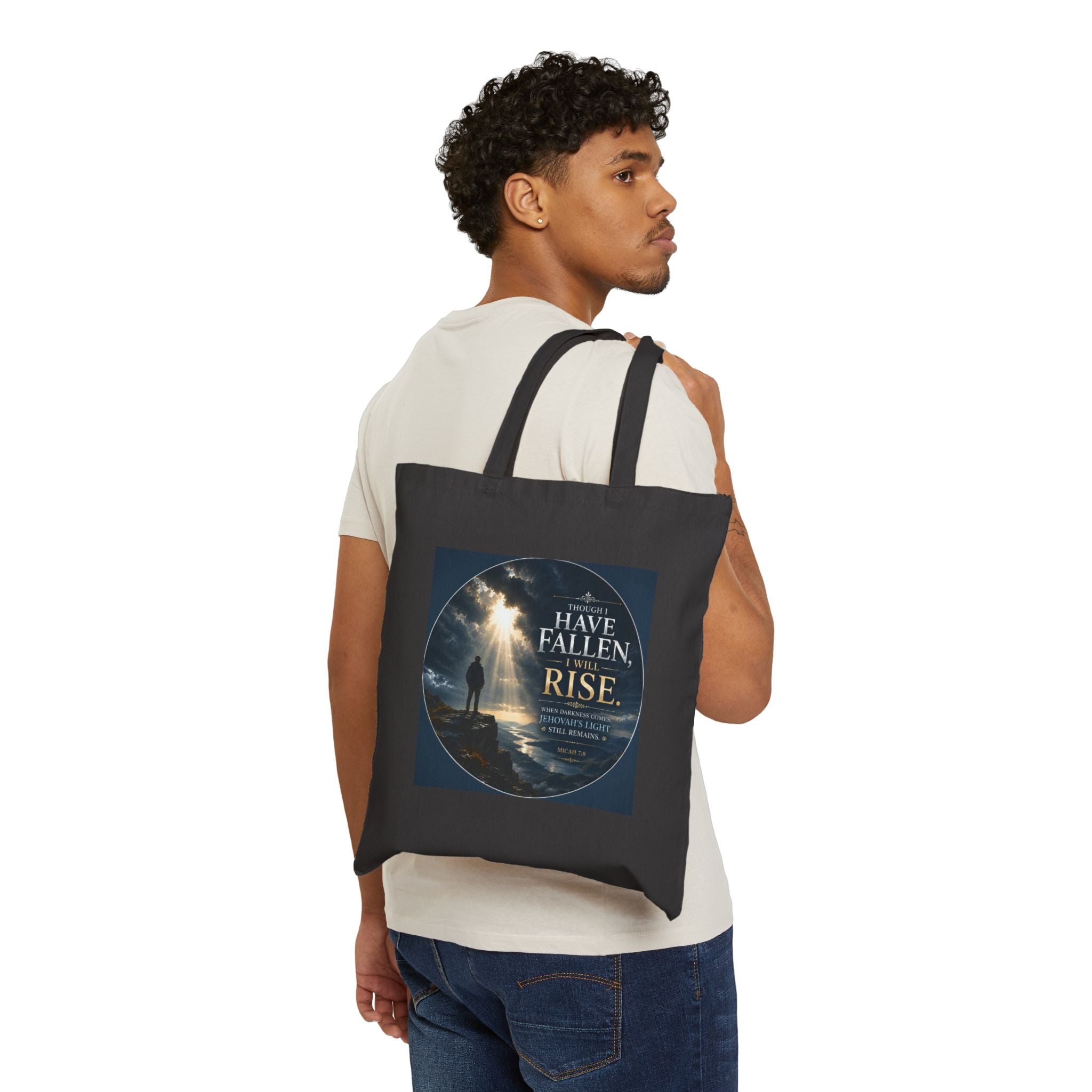 Christian cotton canvas tote bag featuring Micah 7:8 and the message “Though I Have Fallen, I Will Rise,” with dramatic mountain landscape artwork, storm clouds, rays of light, and inspirational faith-based design.