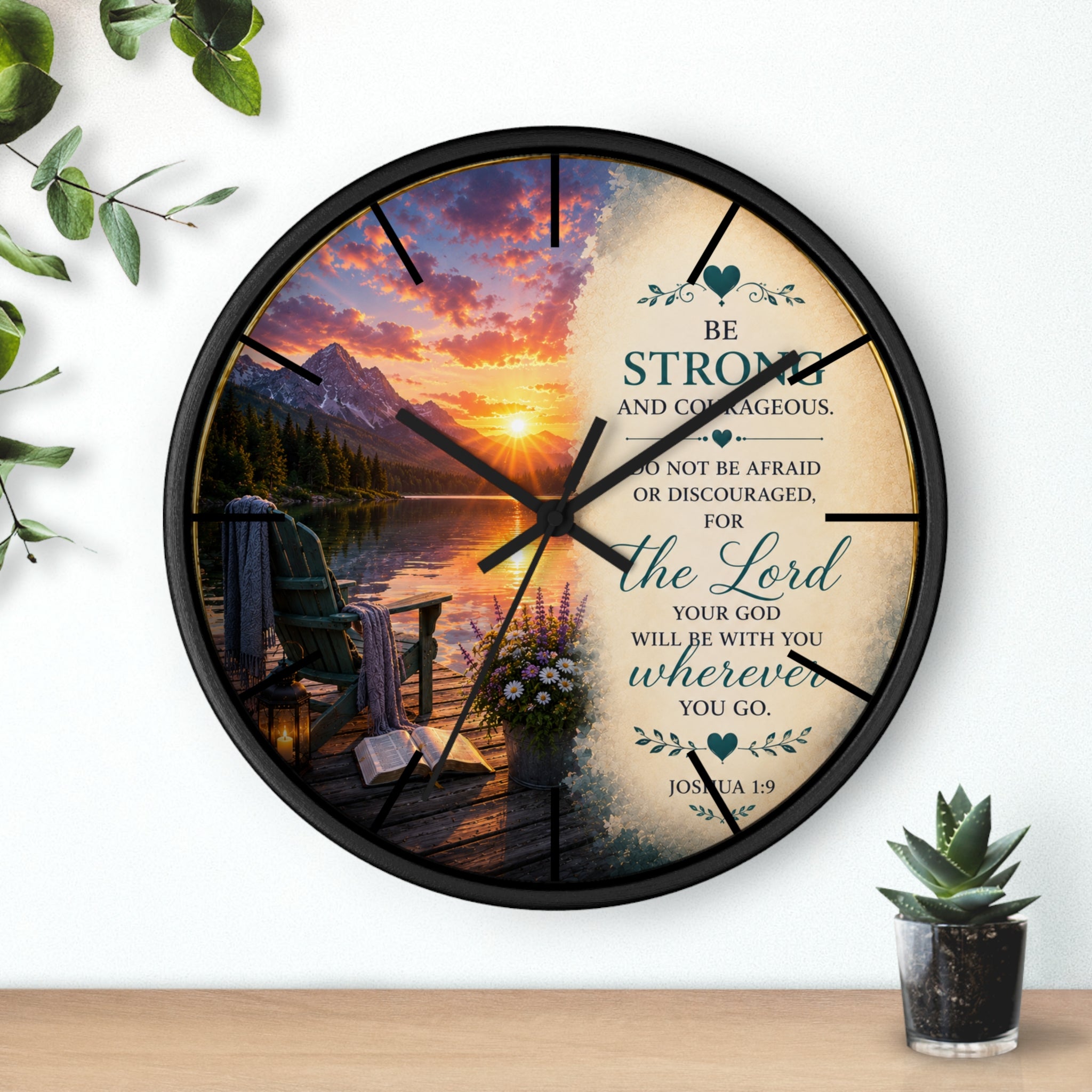 Inspirational Christian wall clock featuring a peaceful lakeside sunrise, mountain scenery, and Joshua 1:9 scripture encouraging strength and courage.