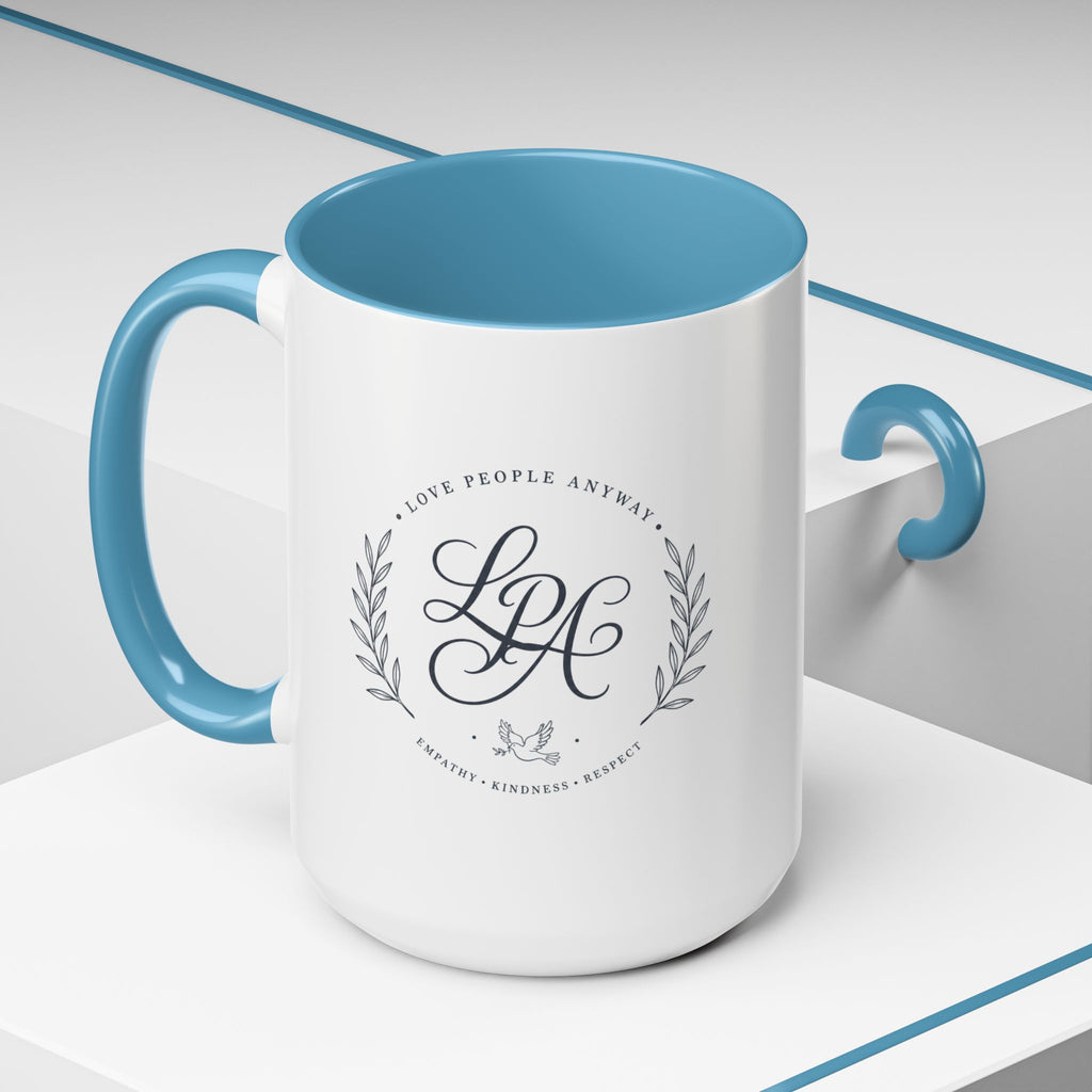 Personalized ceramic accent coffee mug featuring a custom monogram crest and the inspirational message “Love People Anyway” with colorful handle and interior accents.