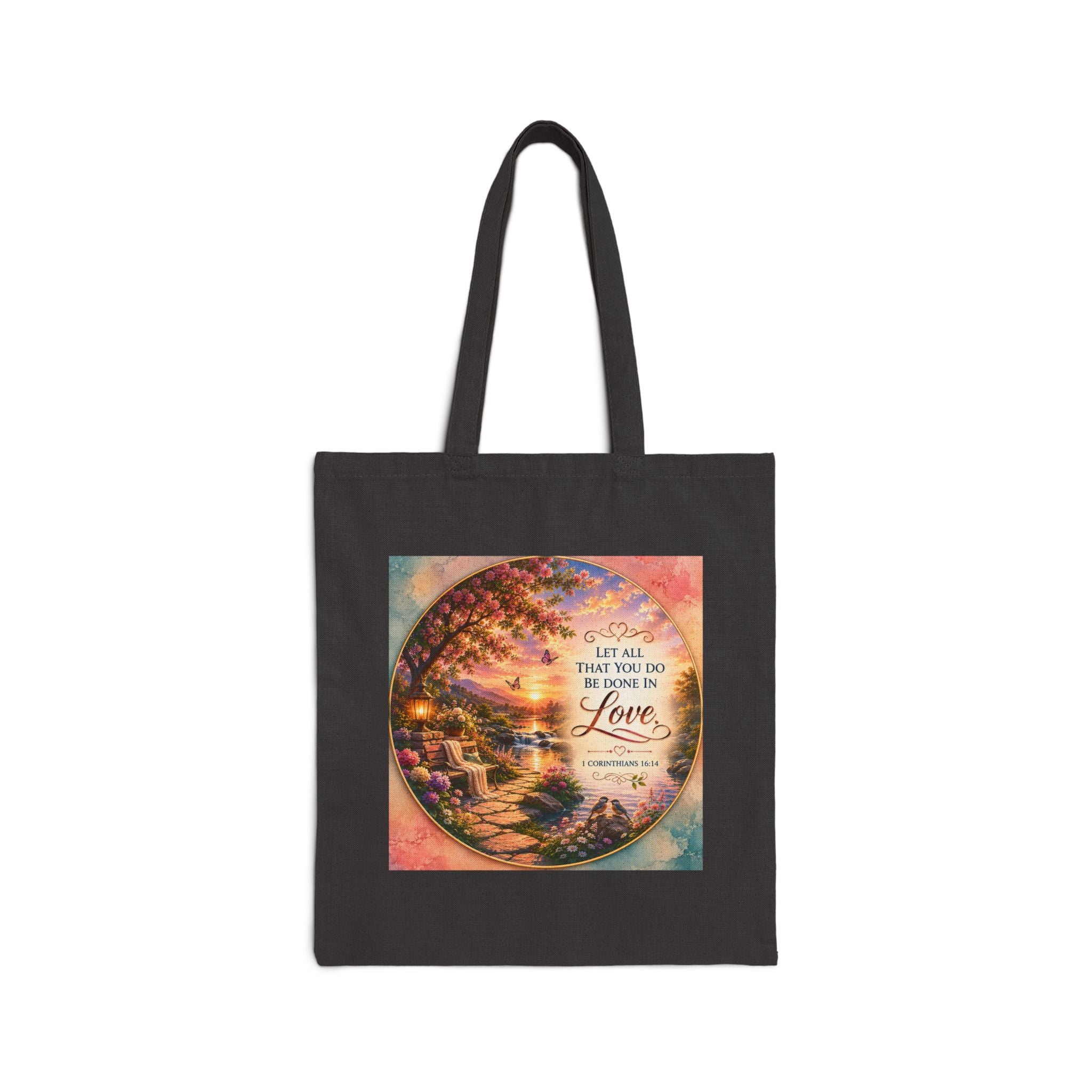 Christian cotton canvas tote bag featuring 1 Corinthians 16:14, “Let All That You Do Be Done in Love,” with a peaceful garden landscape, blooming flowers, butterflies, flowing river, lantern, birds, and sunset artwork.