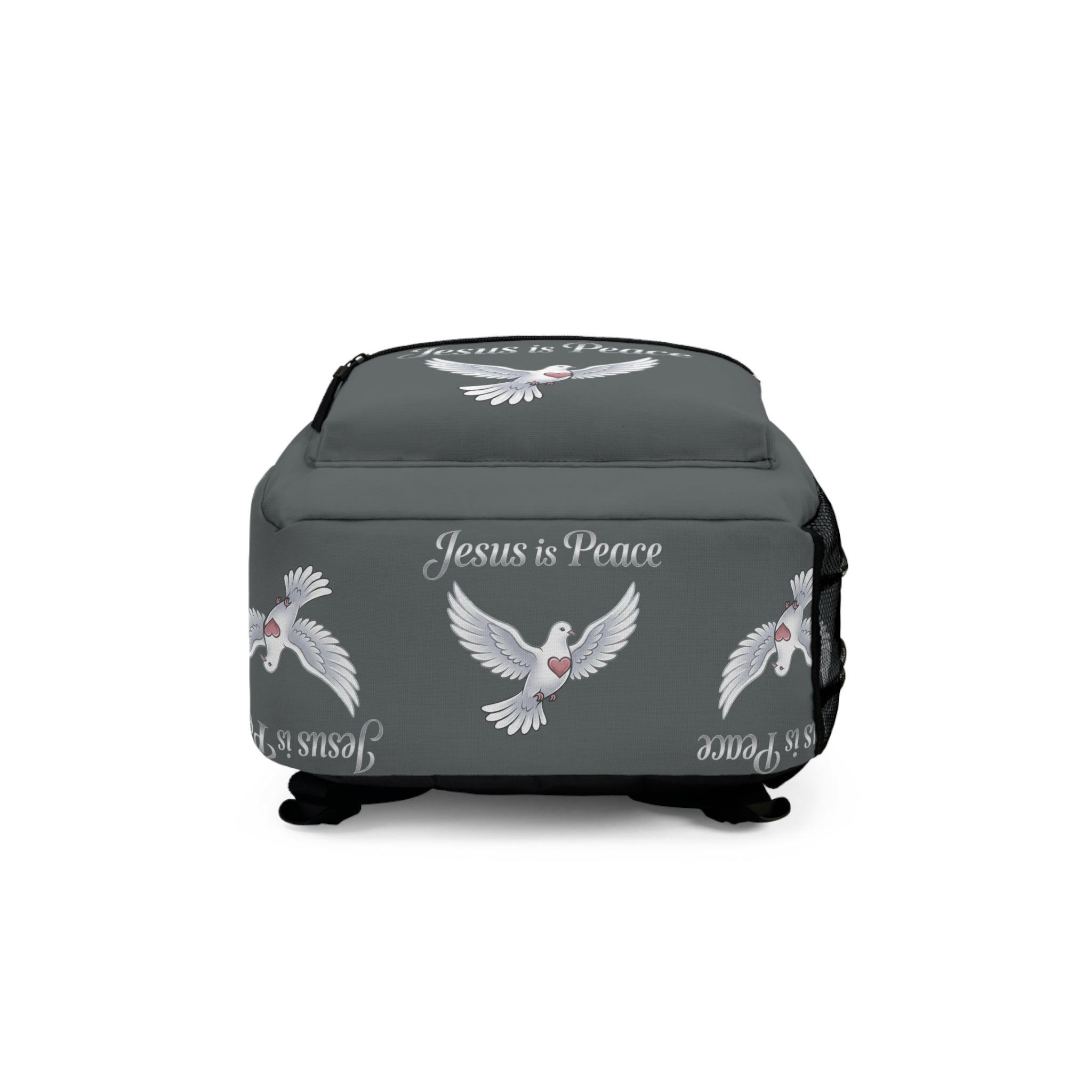 Gray Christian backpack featuring a white dove carrying a heart beneath the words "Jesus Is Peace," with multiple zippered compartments and padded shoulder straps.