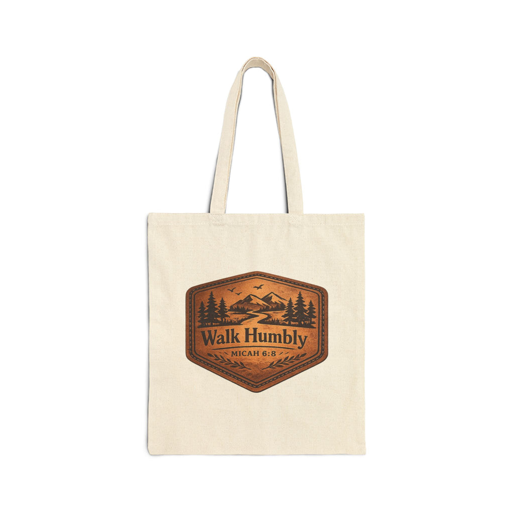 Rustic Christian cotton canvas tote bag featuring Micah 6:8 and the message “Walk Humbly,” with vintage mountain landscape artwork, pine trees, birds, and a winding trail in a leather-patch style design.