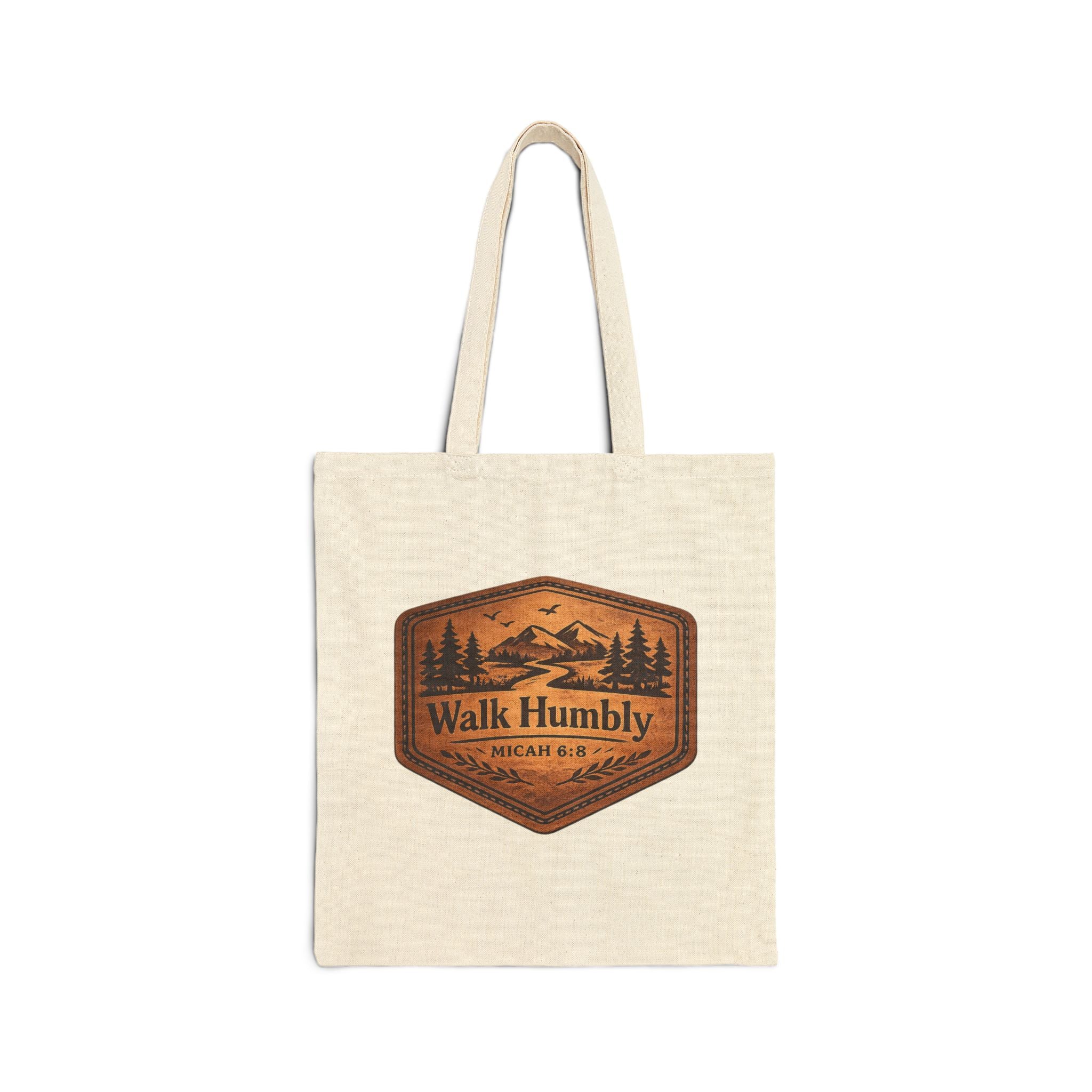 Rustic Christian cotton canvas tote bag featuring Micah 6:8 and the message “Walk Humbly,” with vintage mountain landscape artwork, pine trees, birds, and a winding trail in a leather-patch style design.