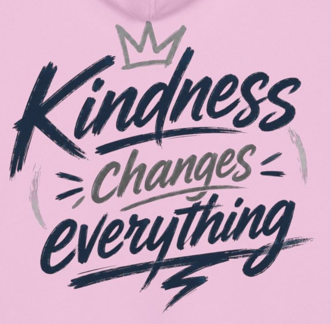 Pink hoodie with 'Kindness Changes Everything' text and a crown graphic on a pink background