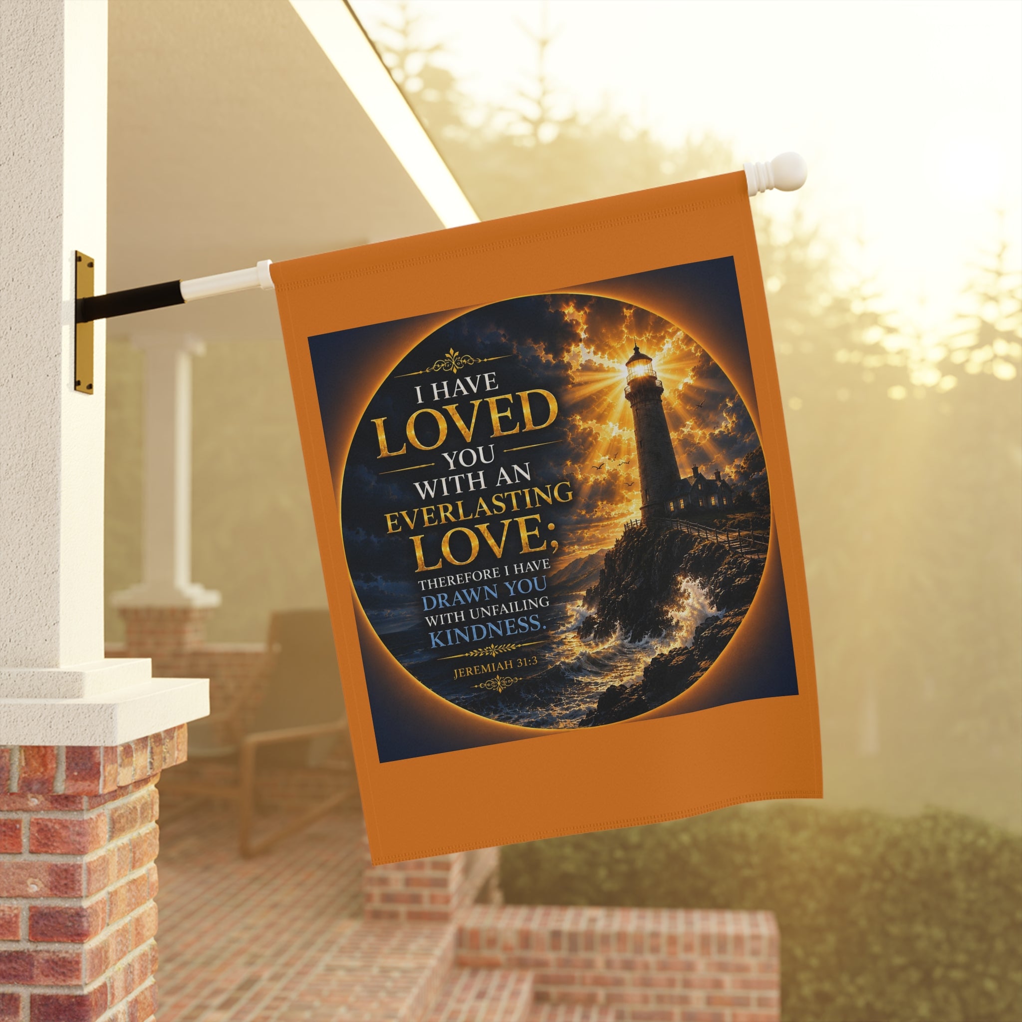 Inspirational Christian garden flag featuring a glowing lighthouse beneath stormy skies with Jeremiah 31:3 everlasting love scripture artwork in coastal-inspired tones.