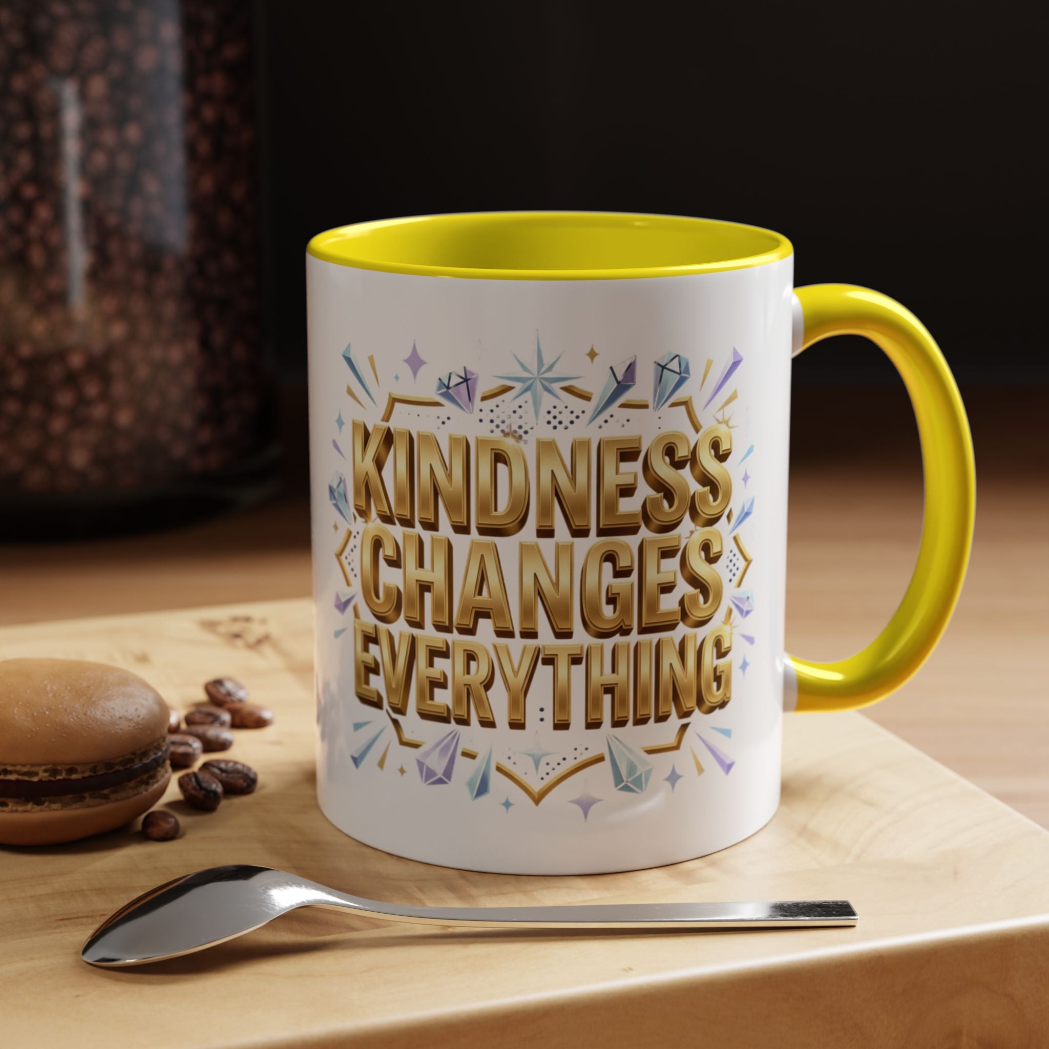 Inspirational ceramic accent coffee mug featuring “Kindness Changes Everything” in elegant gold script with sparkles and colorful accent handle and interior.